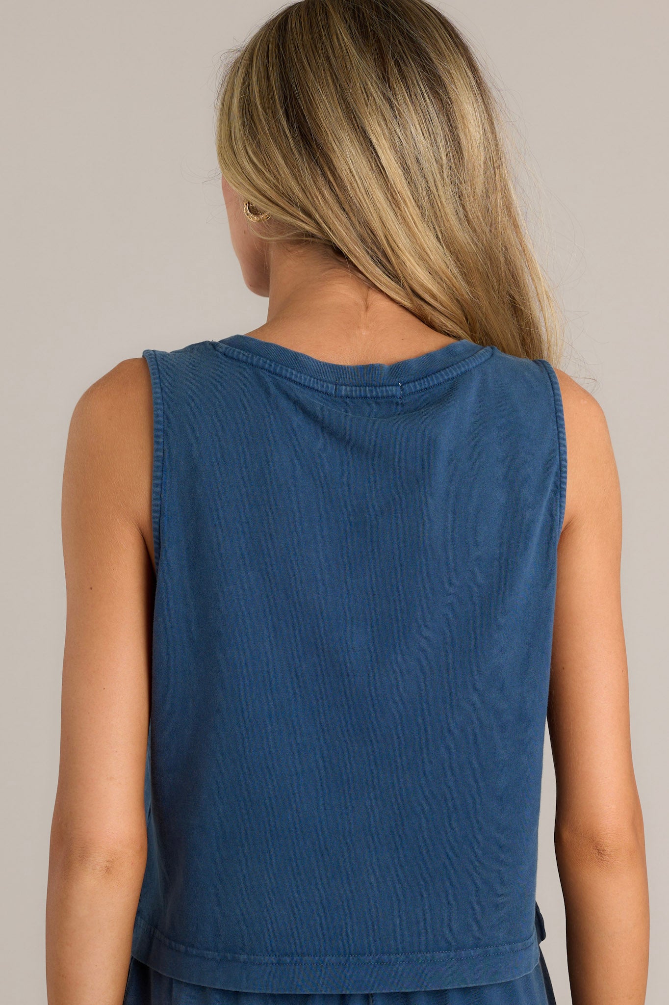 Back view of a blue tank highlighting the overall fit and slightly cropped hemline.