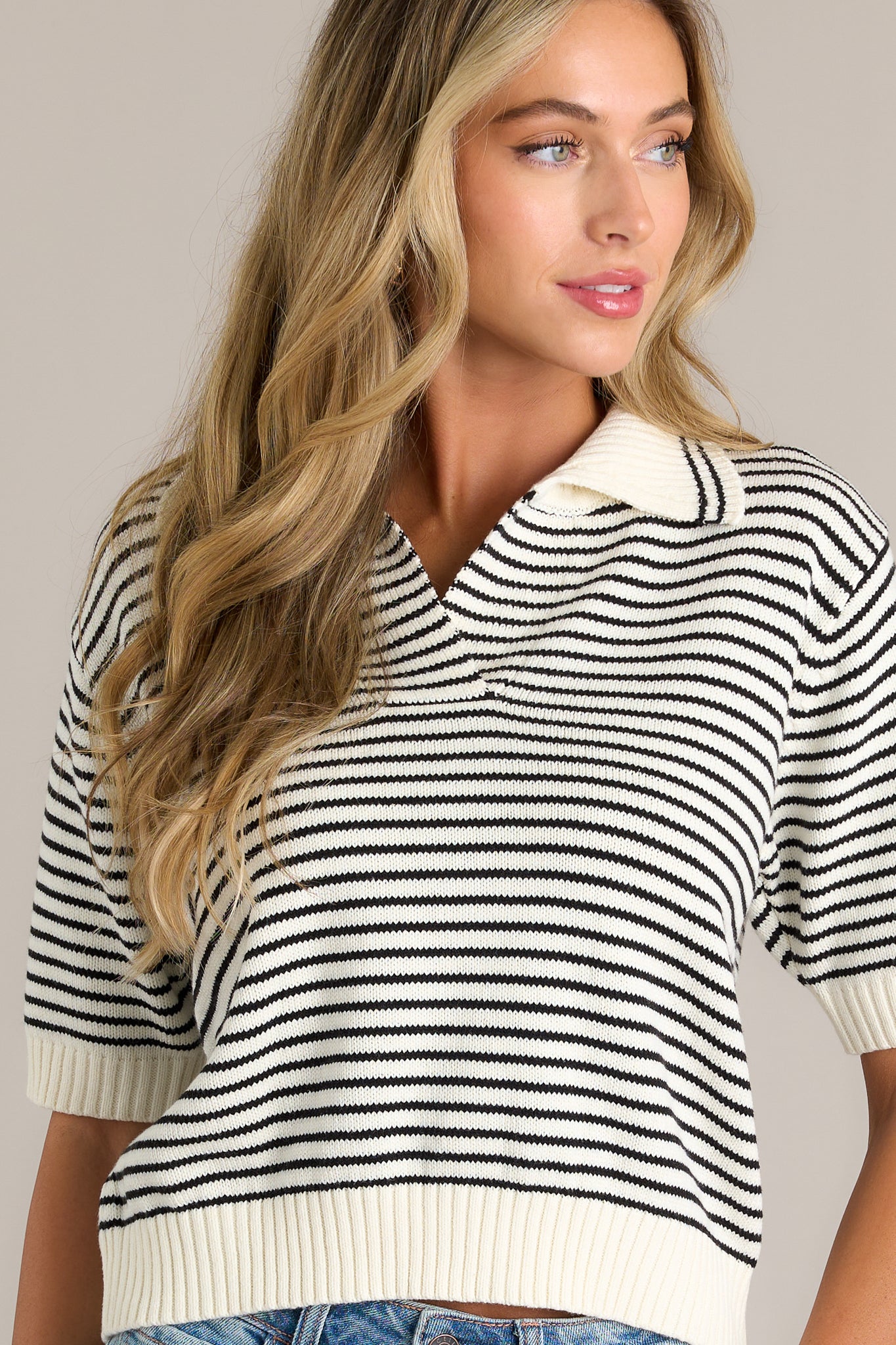 A cropped image focused on the short sleeves, showcasing the thick sleeve hem and the contrast between the stripes and the collar.