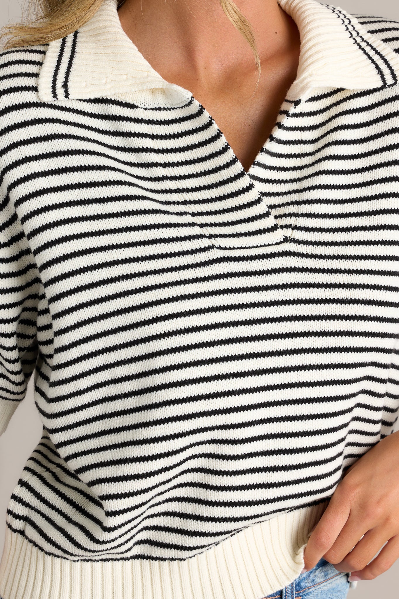 A detailed close-up of the thick hem at the collar and sleeve, showing the knit texture and structure.