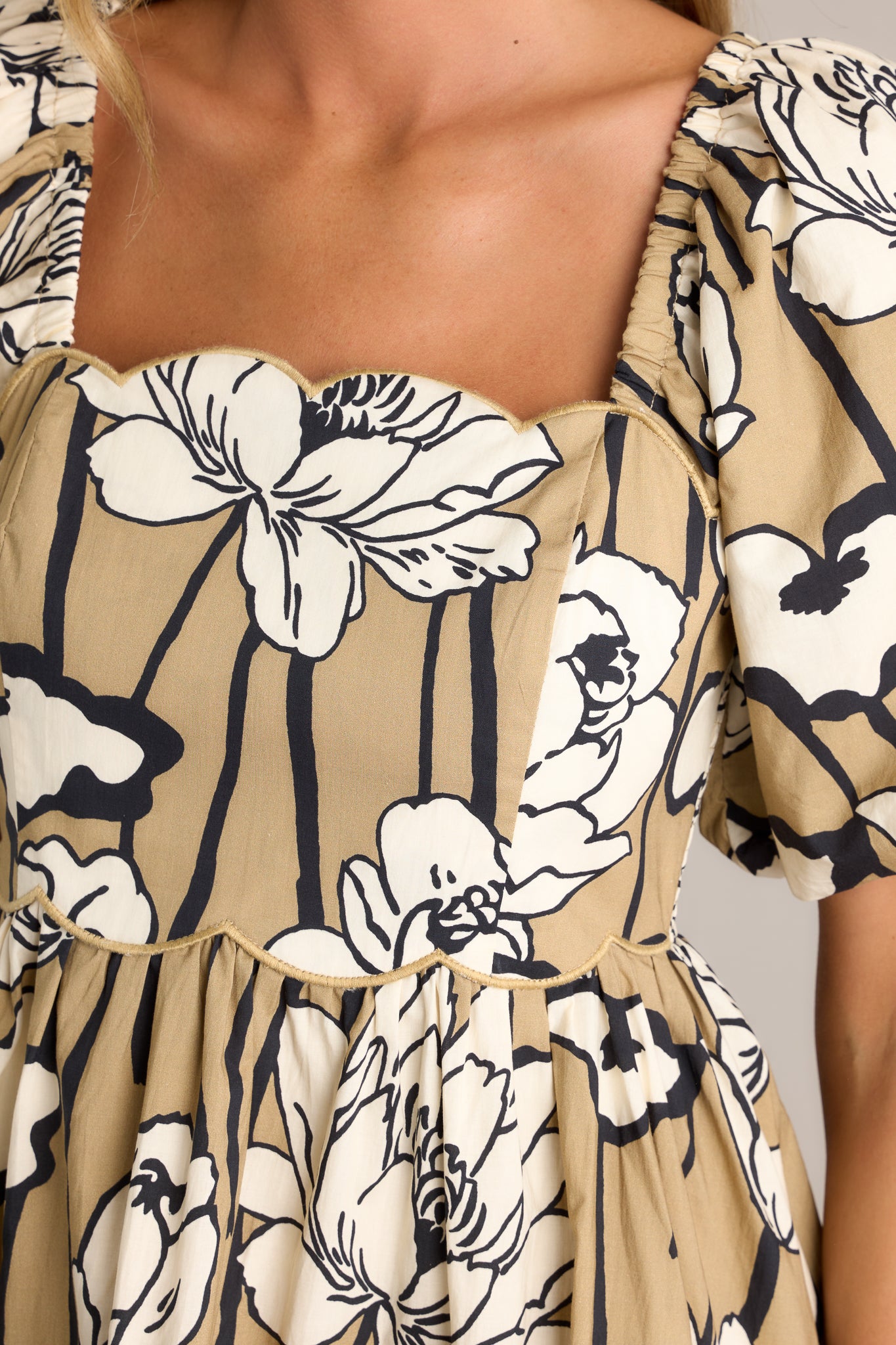 Close-up of the taupe mini dress showing the scalloped neckline, fully smocked back, and scalloped waistline.