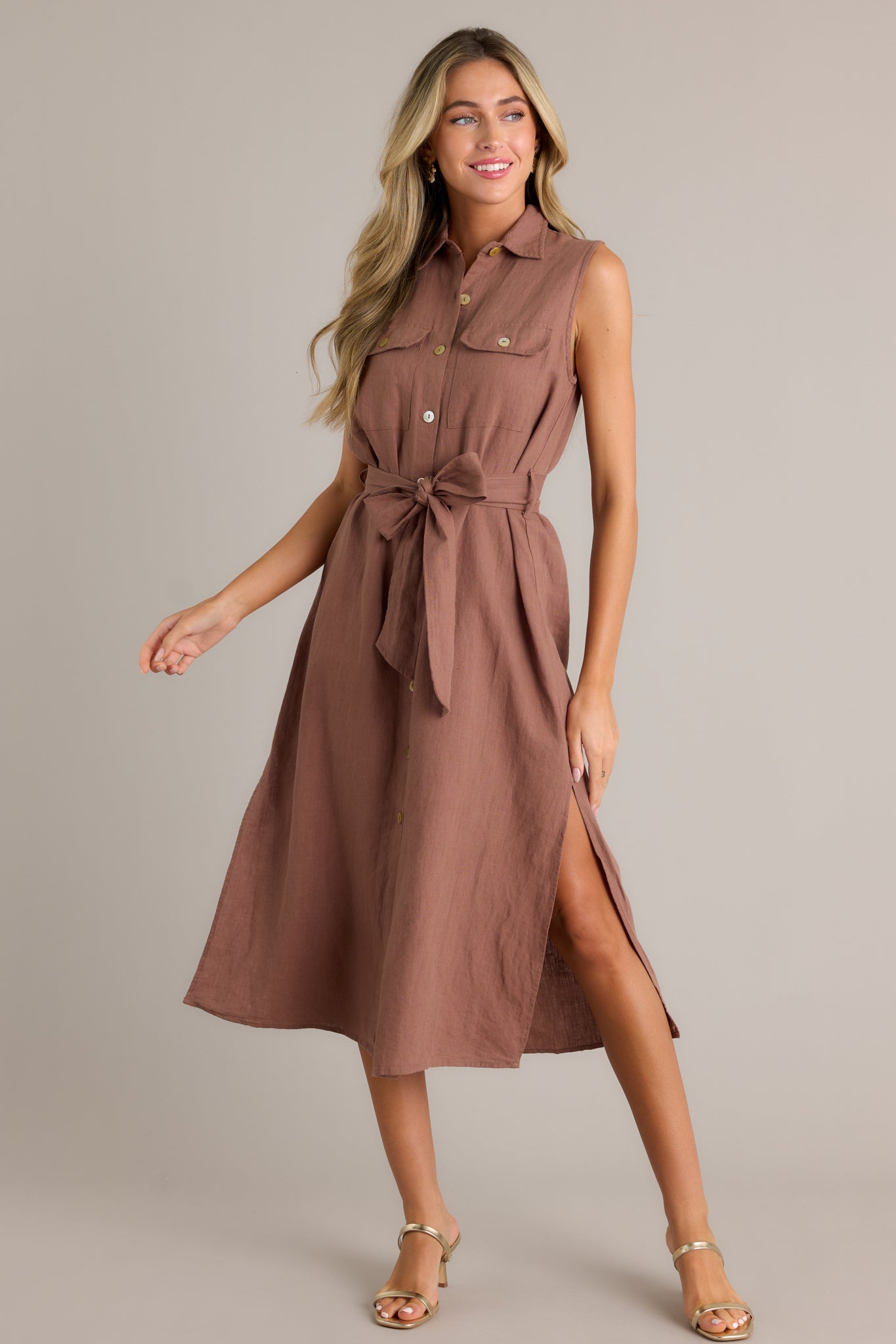 This midi dress features a tie-front belt and a button-front design