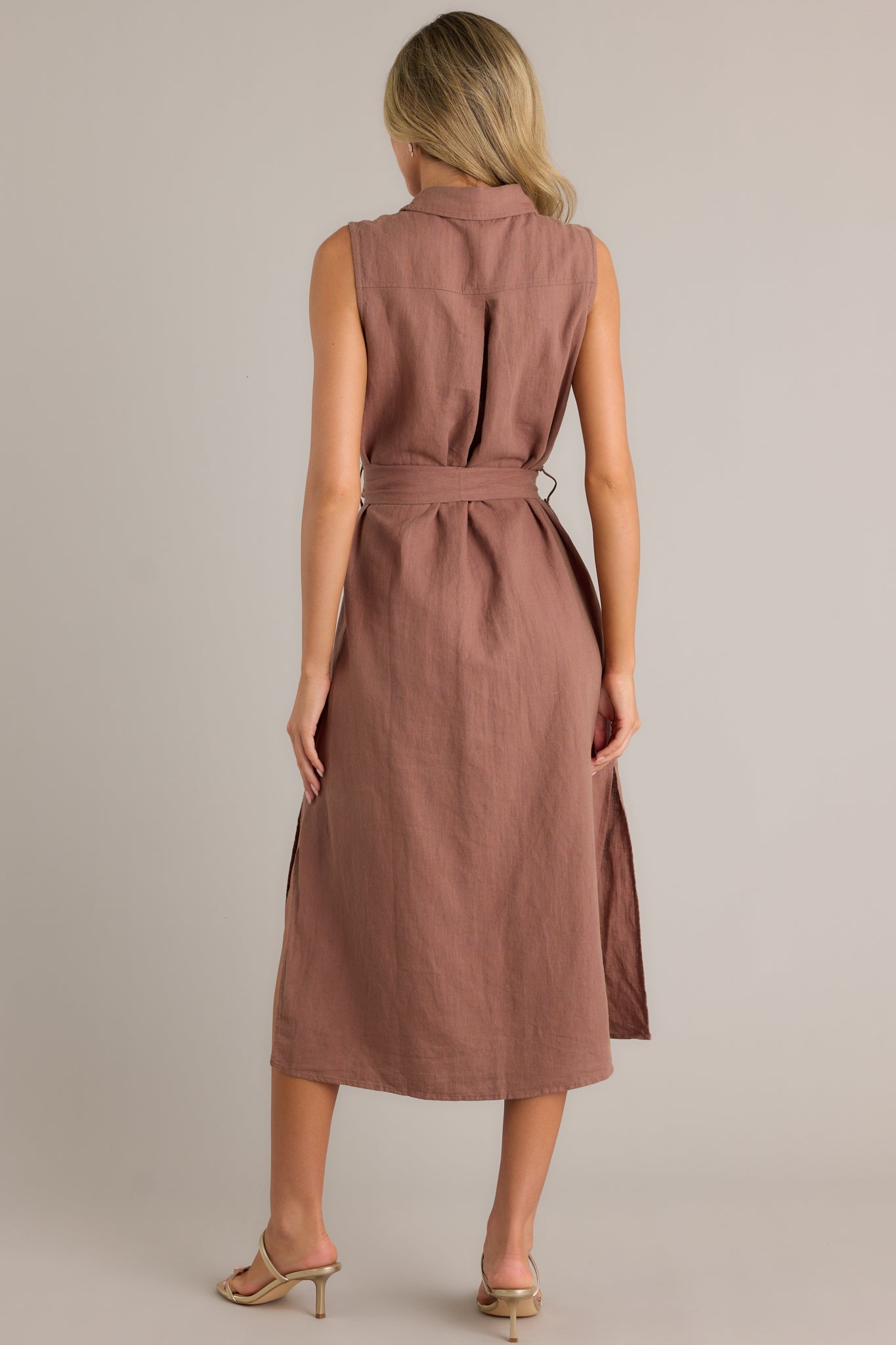 Back view of a midi dress highlighting the overall fit and the tie-front belt.