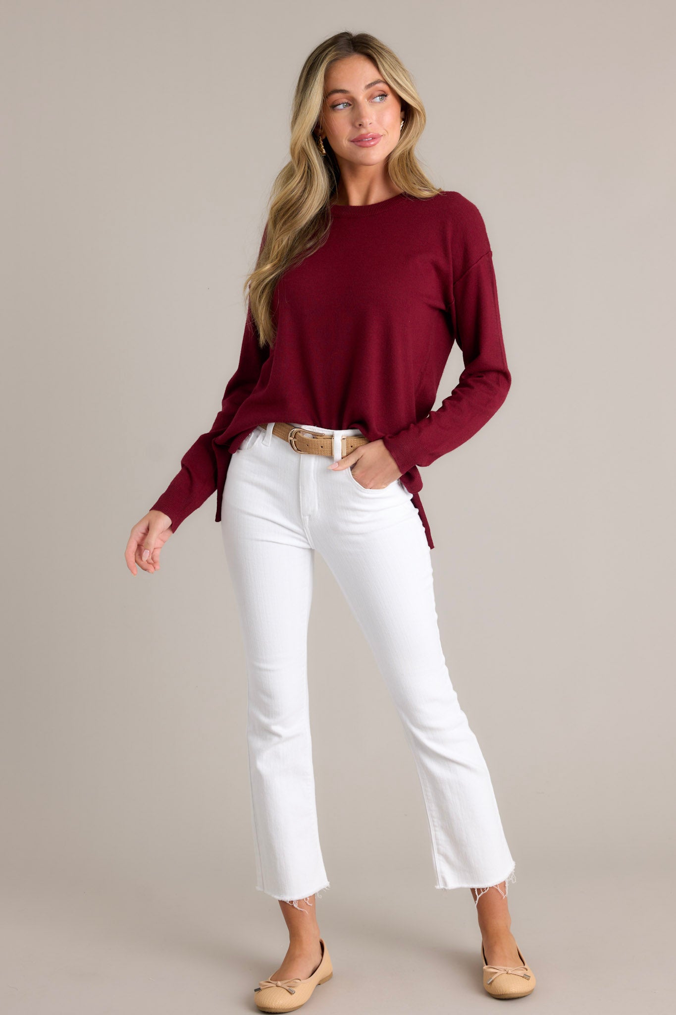 Full body view of this sweater that features a round neckline and long sleeves with ribbed cuffs.