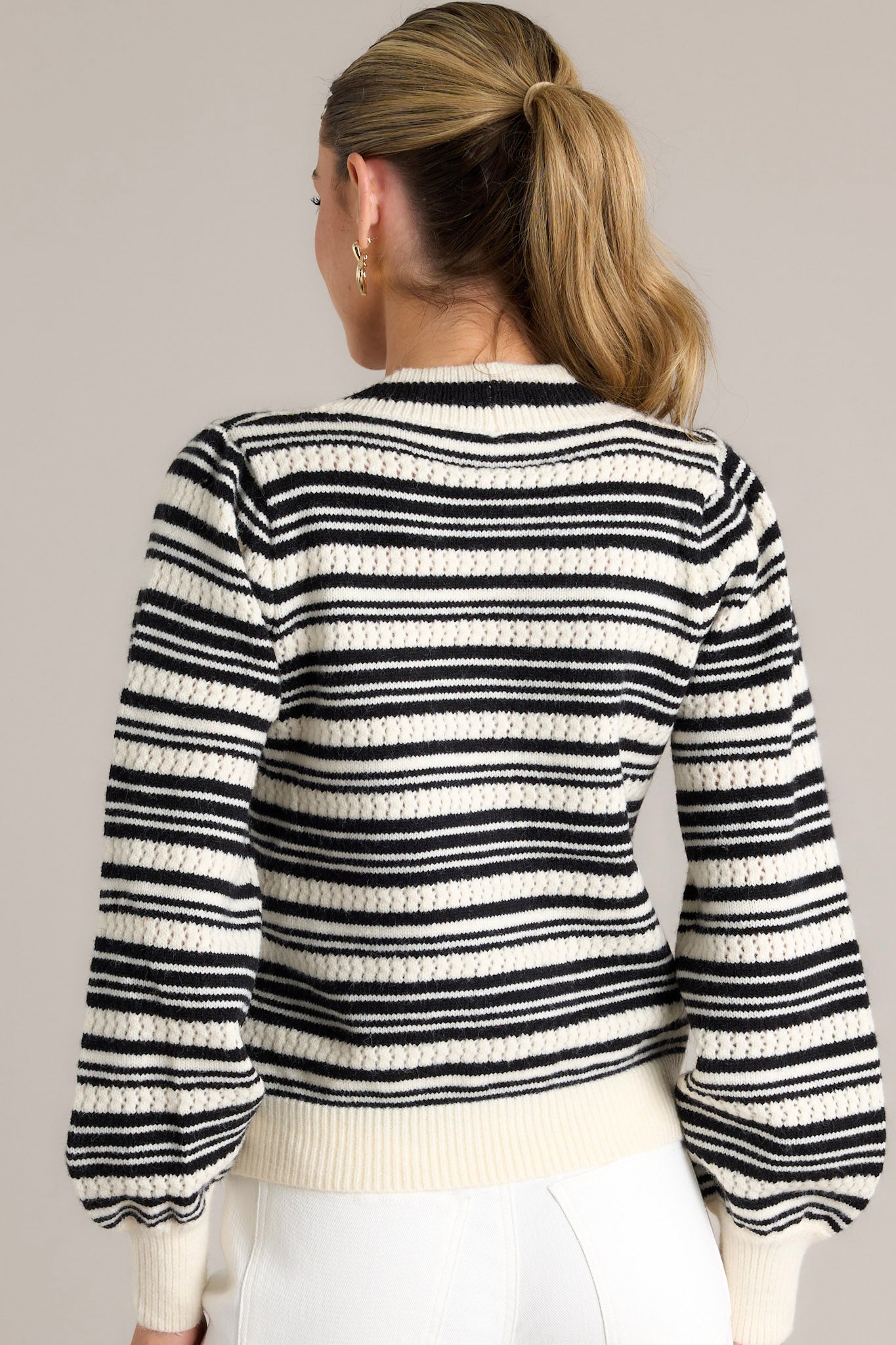 Back view of the stripe sweater top featuring the classic horizontal stripe design, thick hem, and cuffed long sleeves.