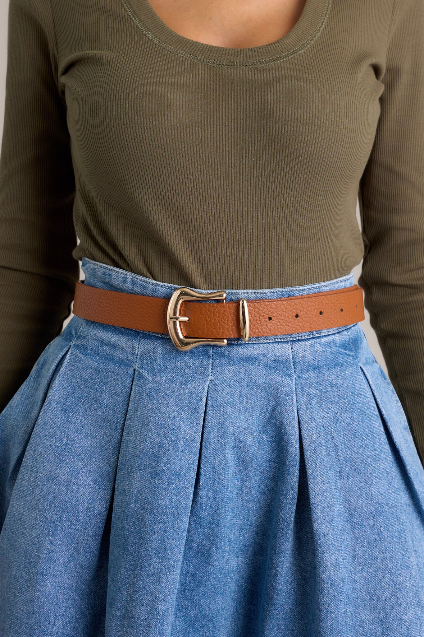 This brown belt features a gold rounded square shape buckle, a gold point at the end of the belt and a brown textured belt.