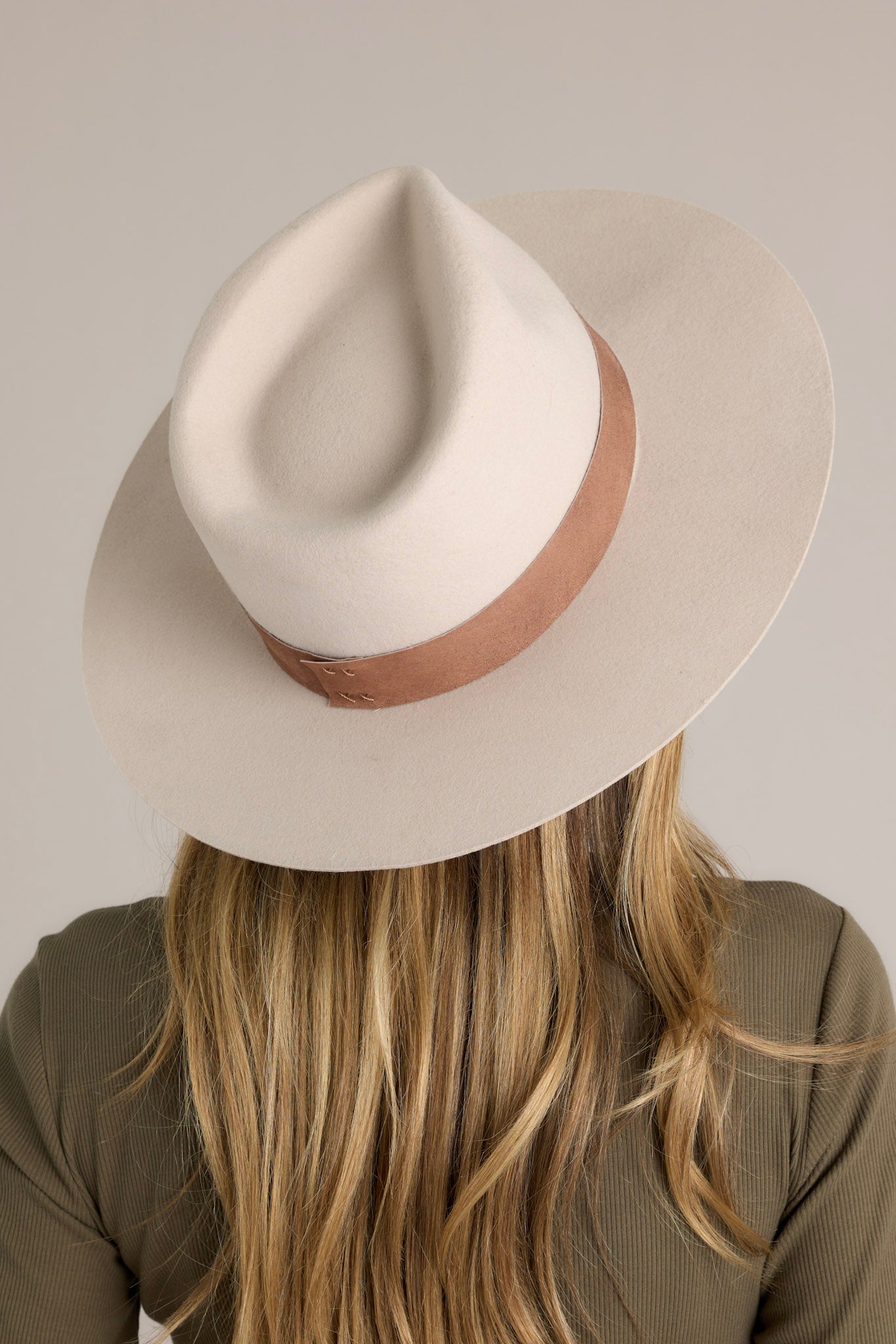 This hat features a flat brim and an attached suede brand.