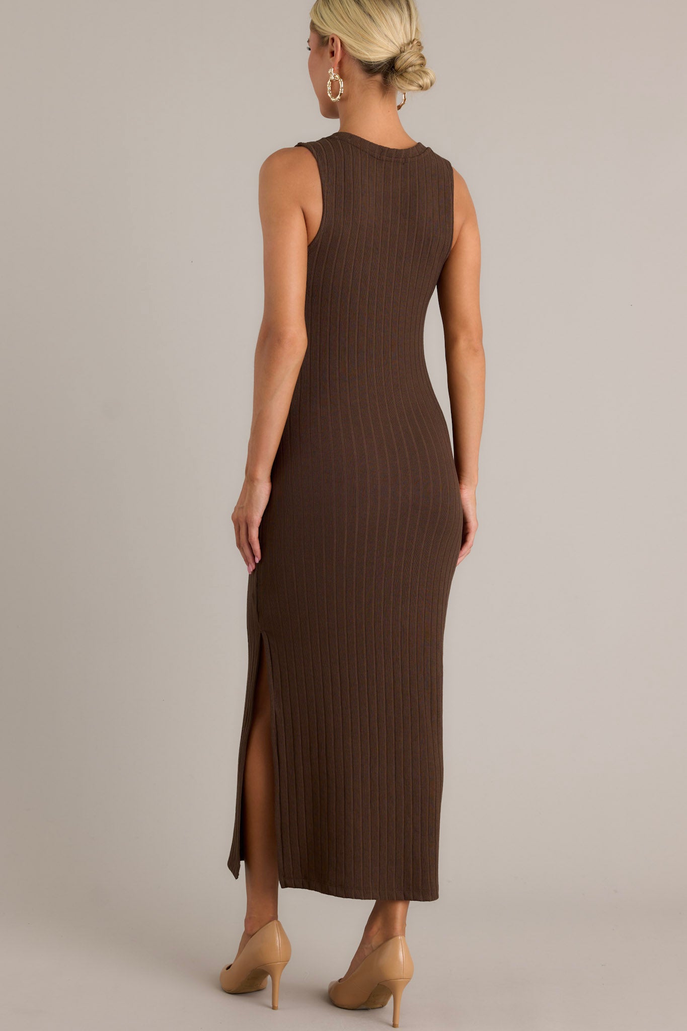 Back view of the brown dress highlighting the bodycon fit and the smooth ribbed fabric, along with the sleeveless design