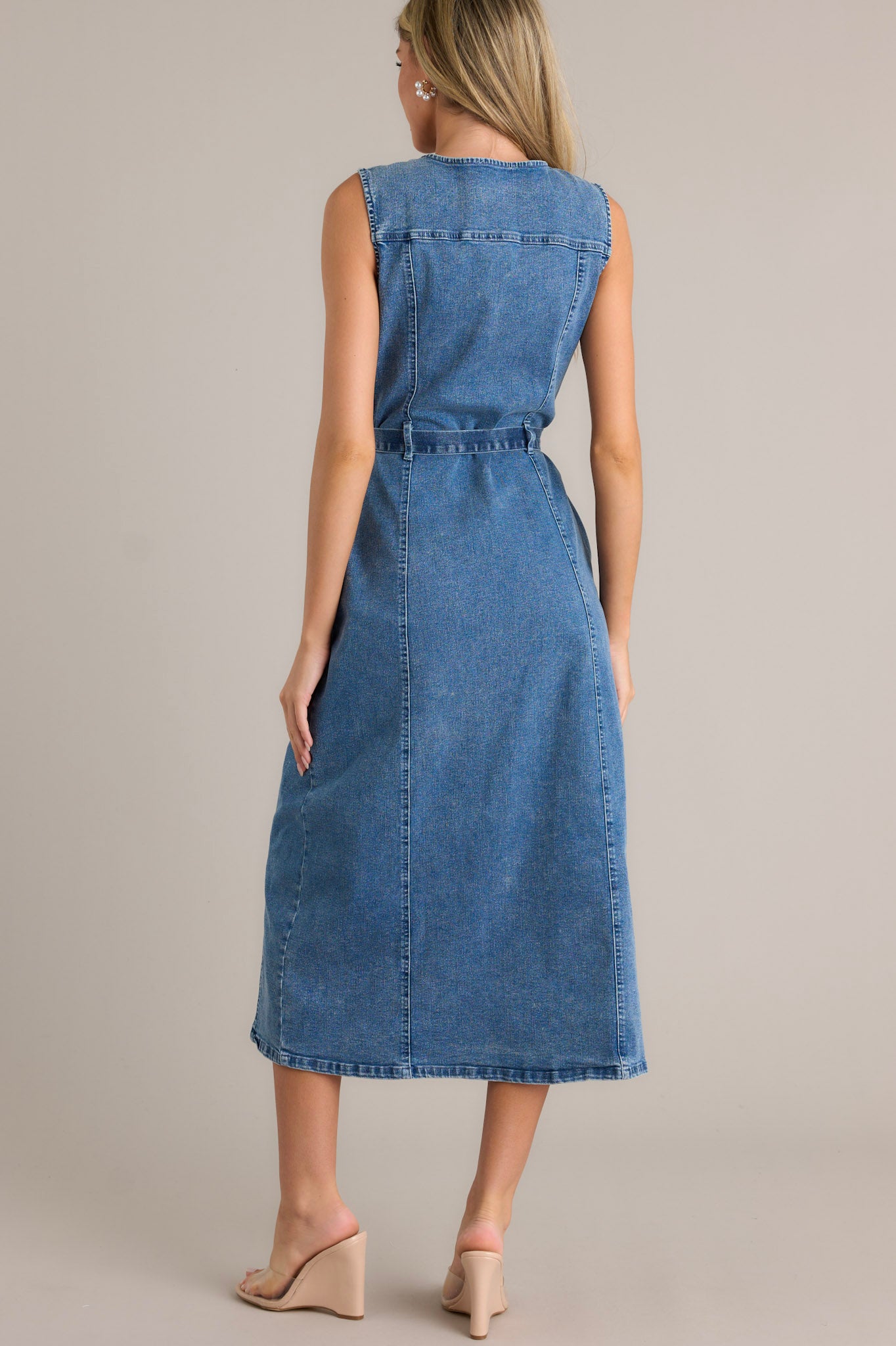 Back view of the denim dress highlighting the self-tie denim drawstring belt, sleeveless design, and the overall fit of the dress.