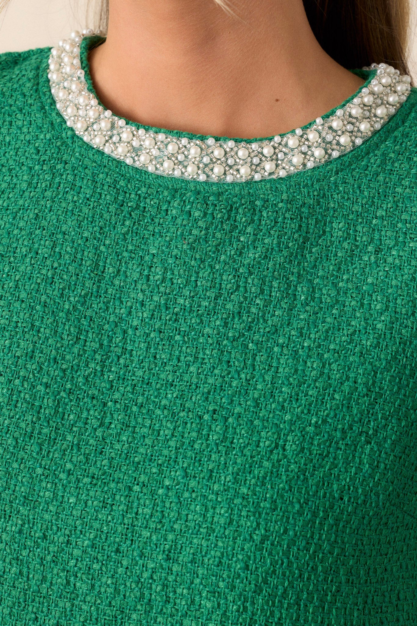 Close-up of the jade green top focusing on the intricate jewel embellishments on the collar.