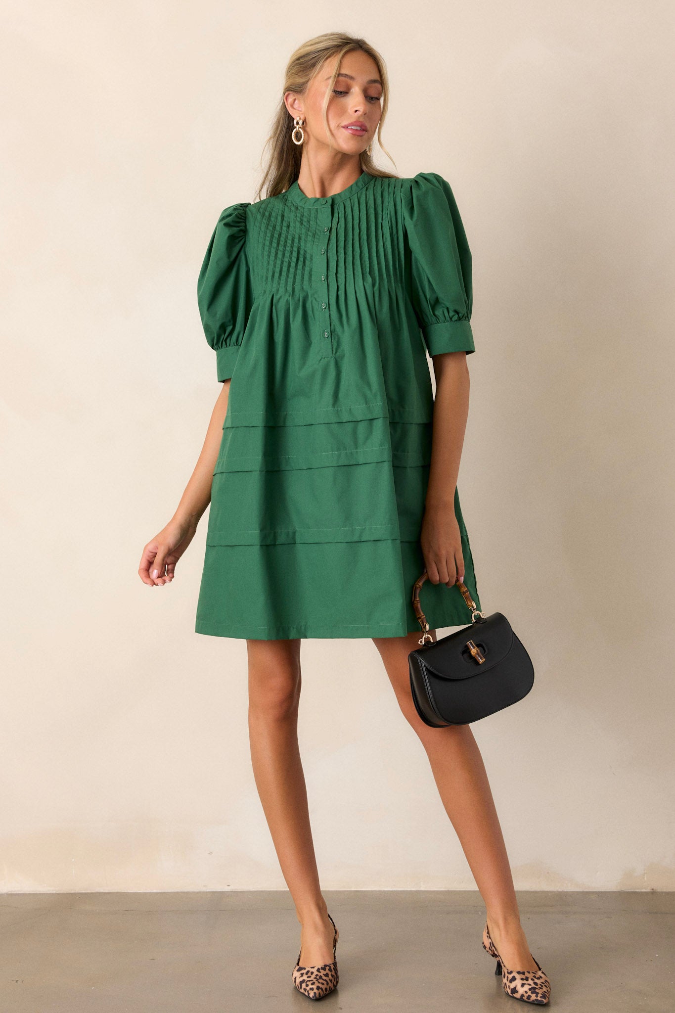 This dress featured two side pockets, a functional button-front and puff sleeves.