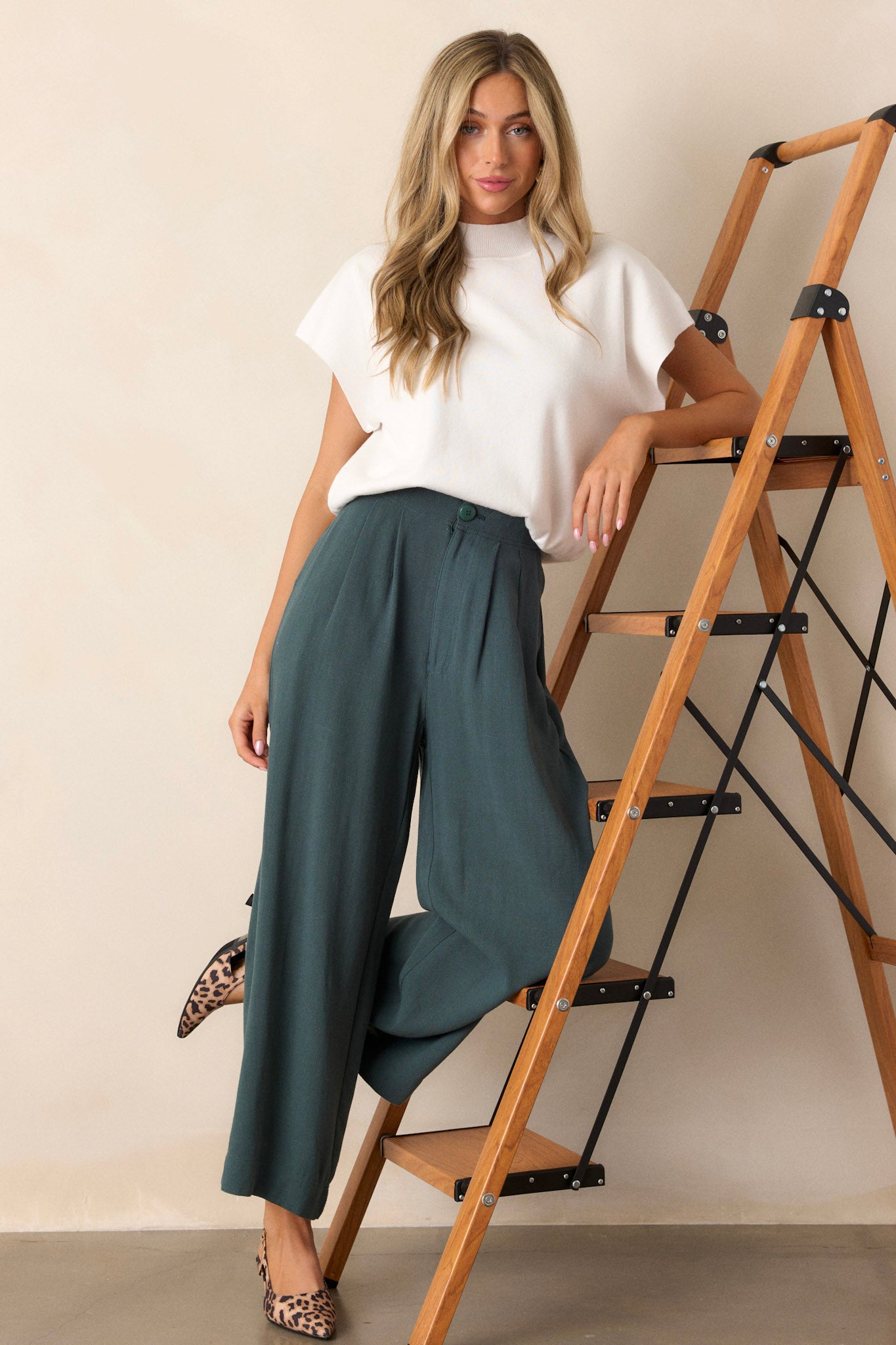 These green pants feature an elastic waist insert, a button zipper closure, functional hip pockets and a straight leg.