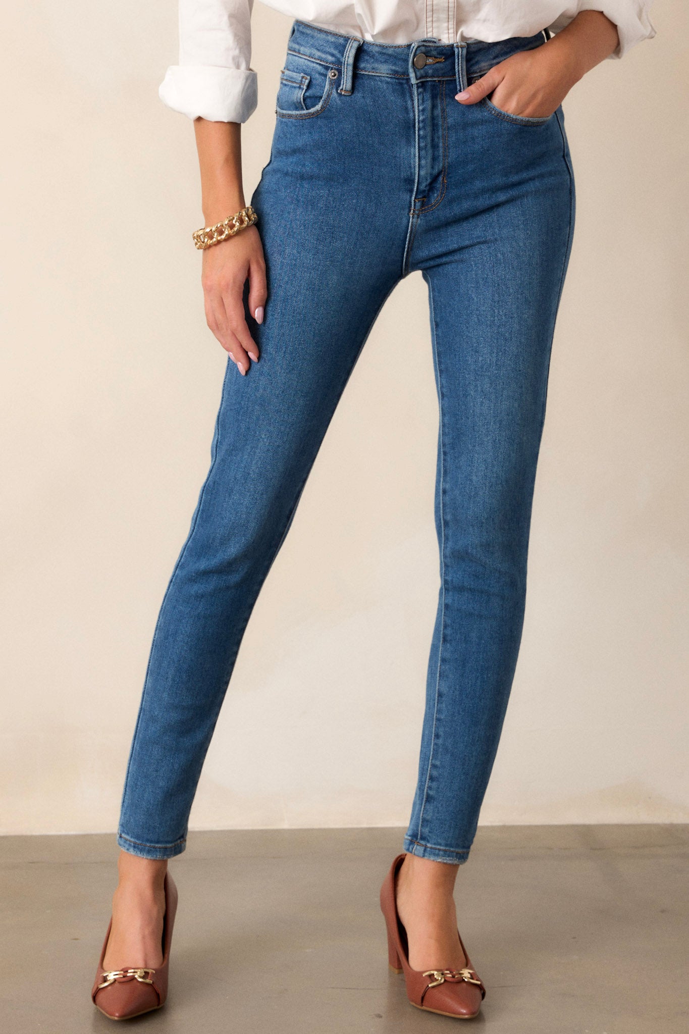 A lower cropped view showcasing the relaxed fit around the ankles, emphasizing the tapering effect of the skinny jeans.