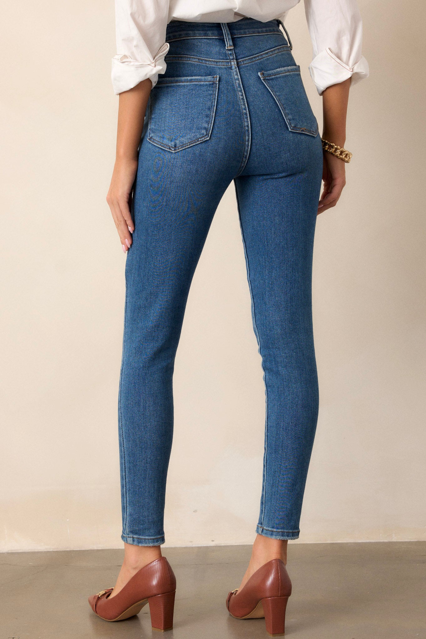 A view from the back of the skinny jeans, displaying the functional back pockets and the high-waisted design that contours to the body for a flattering fit.