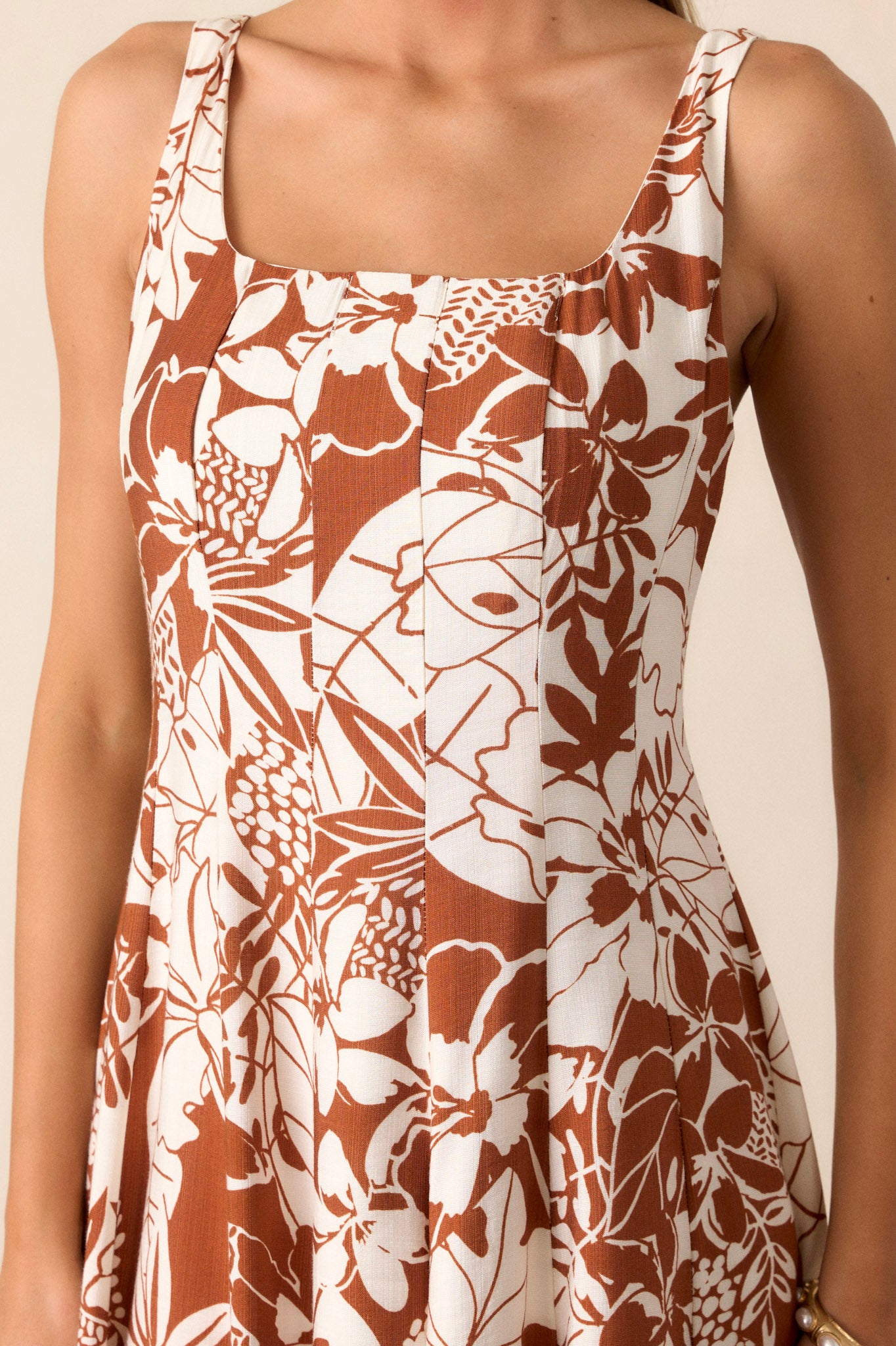 Close-up of the floral dress focusing on the pleated design, showing the texture and the ease of movement it offers