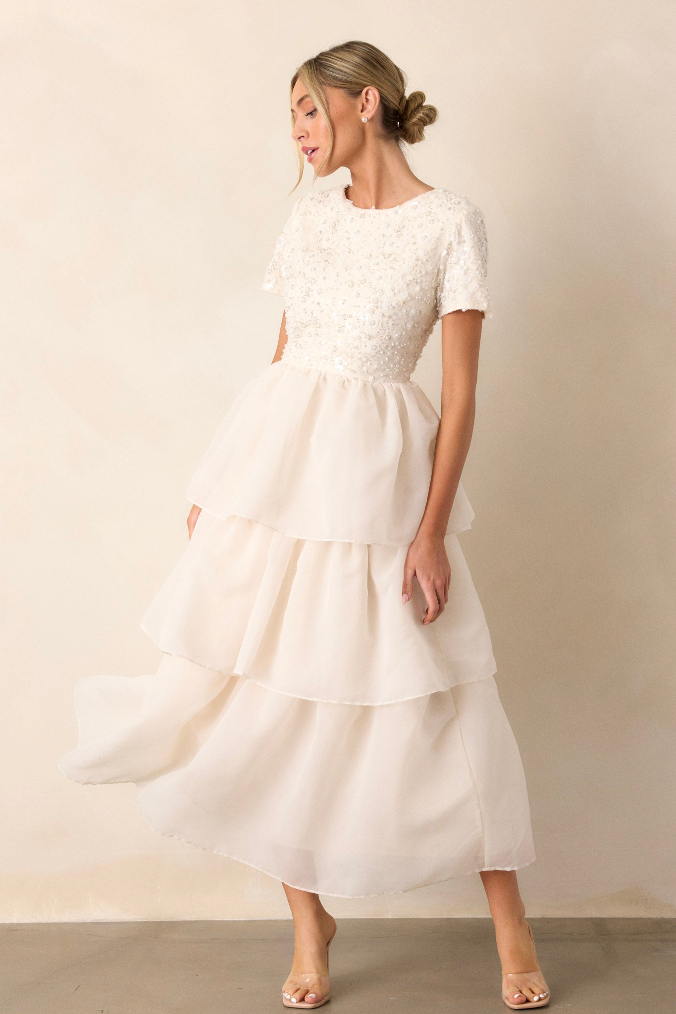 This dreamlike dress features a back zipper, tulle tutu-like tiers and pearls all over the top.