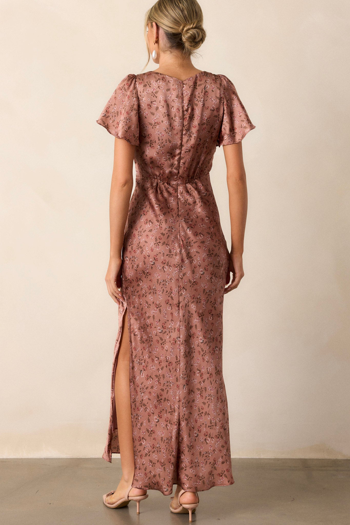 Back view of the dusty rose dress highlighting the functional back zipper and the graceful drape of the fabric.