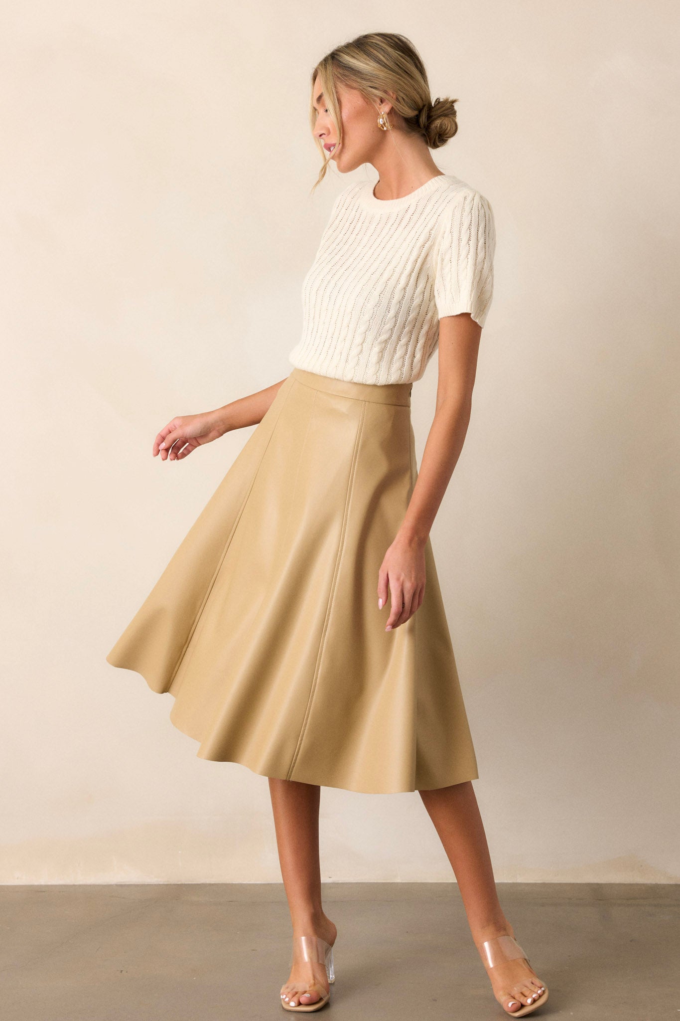 This skirt features an a-line design, stitch detailing on the seams, a side zipper, and stunning faux leather fabric.