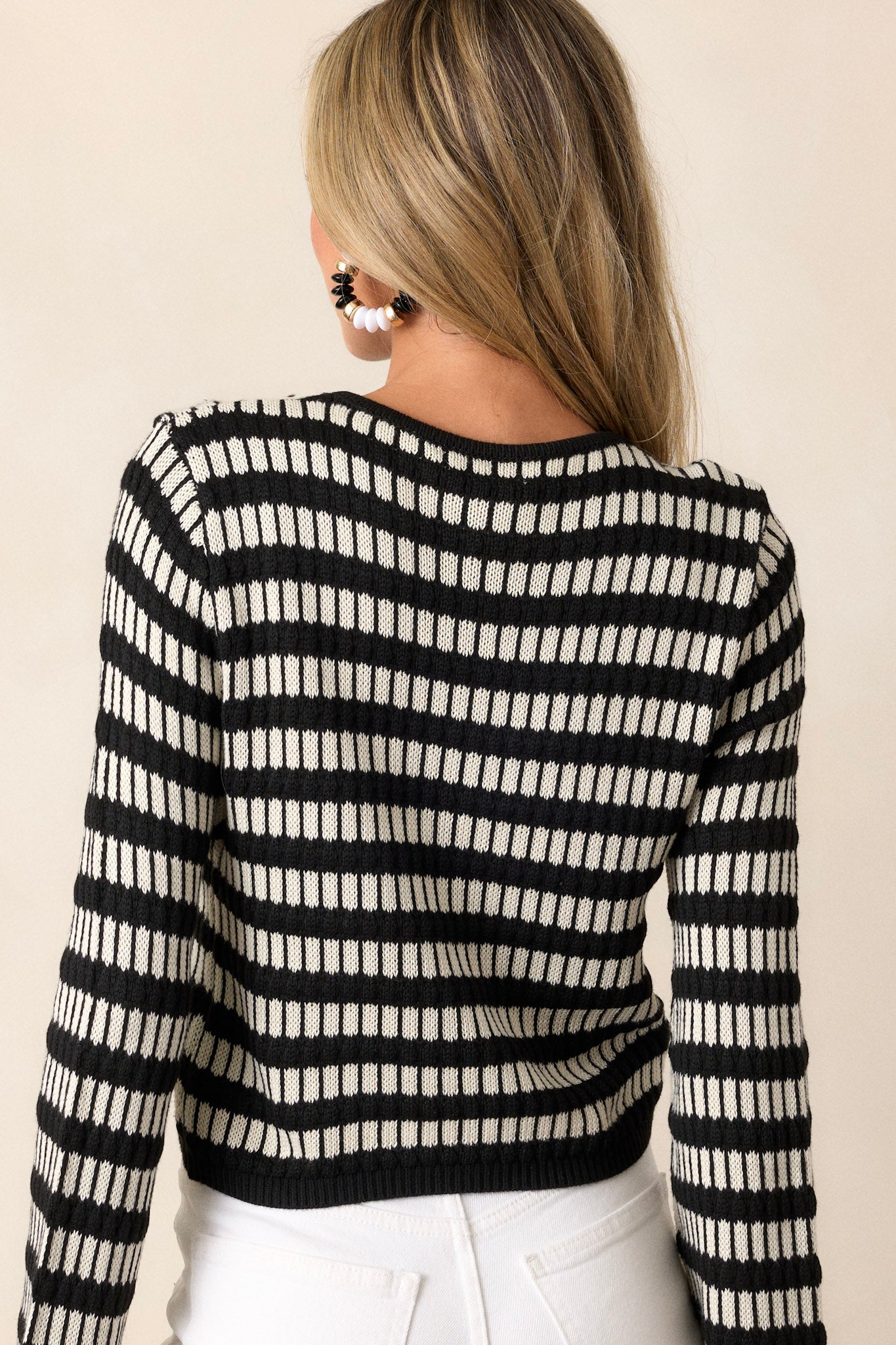 A view of the back of the top, highlighting the simplicity of the design while continuing the horizontal and vertical stripe pattern.