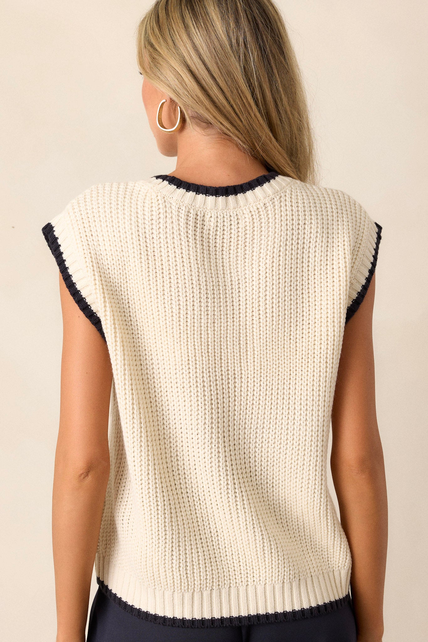 Back view of the knit sweater top highlighting the soft knit texture, cap sleeves, and the continuation of the ivory trim around the neckline