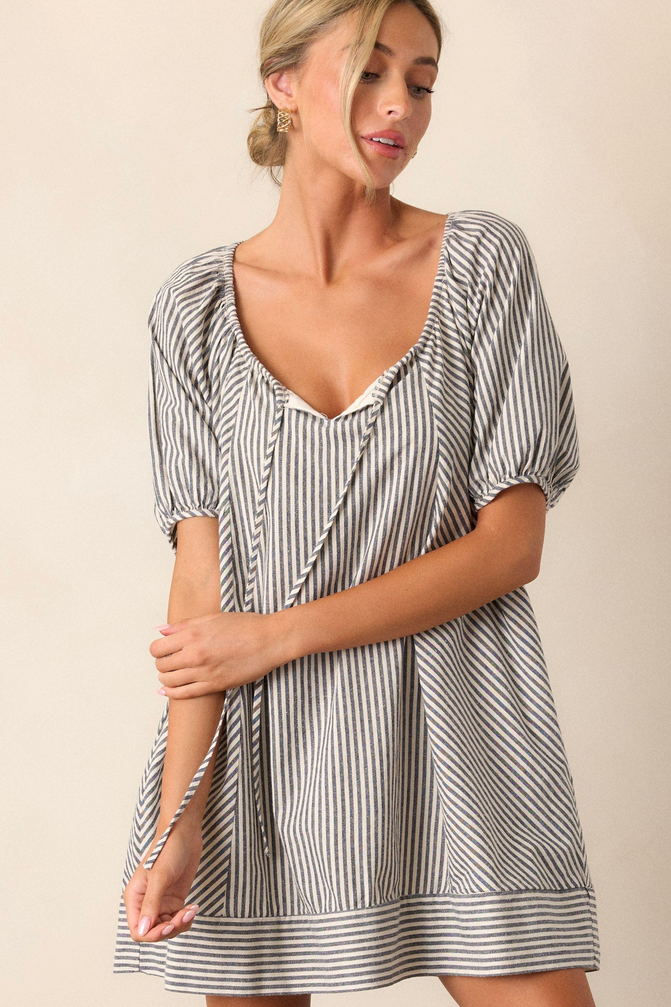 Front view of the dress capturing the elastic shoulders and the flattering silhouette, emphasizing the stylish navy stripes.