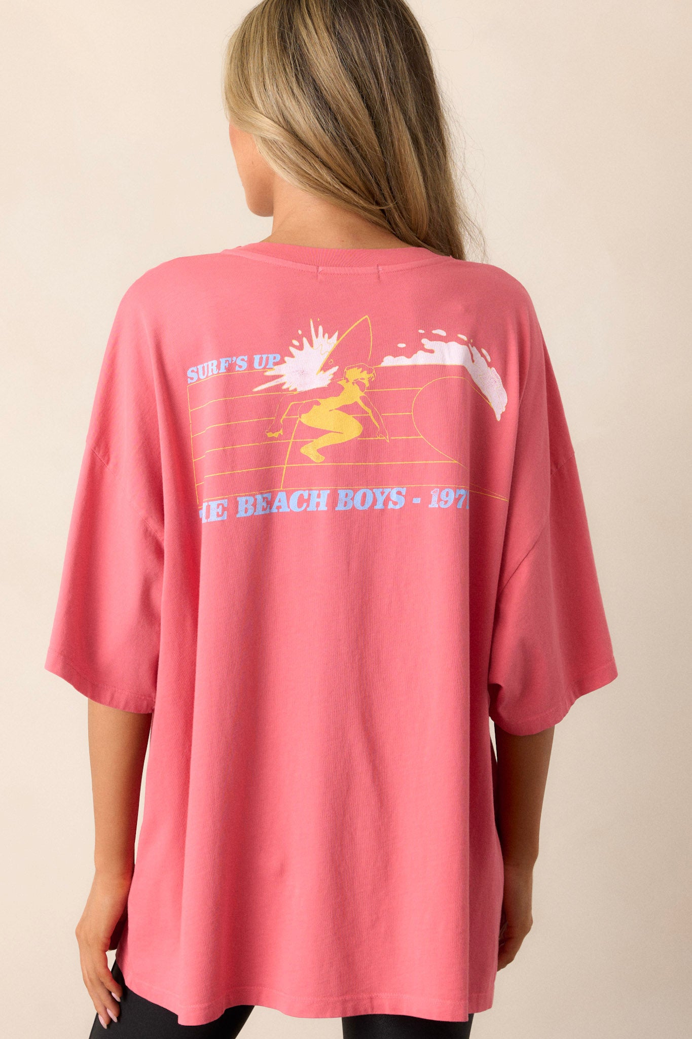 Back view of pink oversized tee in breathable cotton, showcasing the relaxed fit and short sleeves.