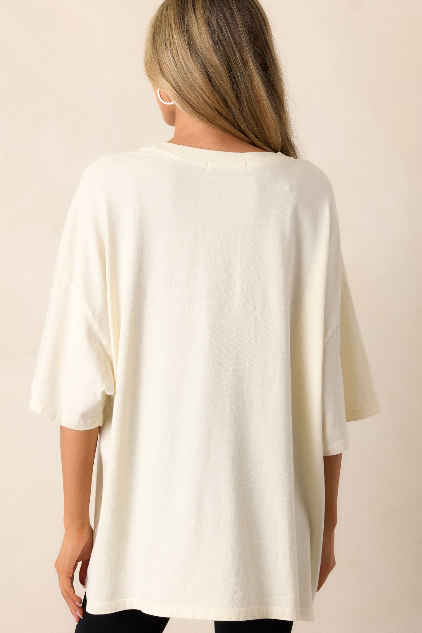 Back view of the ivory oversized tee, showing plain fabric and a relaxed, oversized fit.