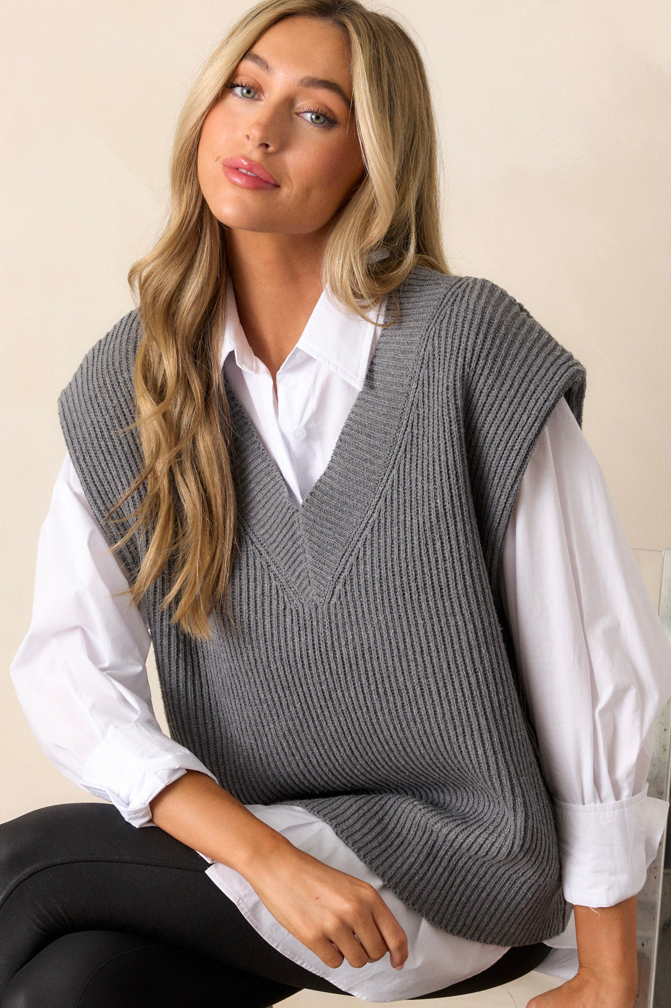 A closer view of the vest’s v-neckline, focusing on the ribbed detailing and how it frames the upper body.