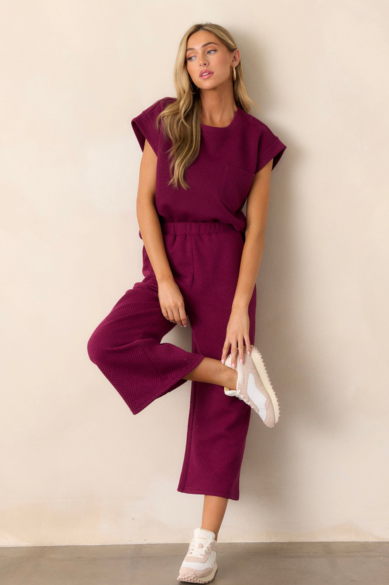 Action shot of these sangria purple pants displaying the flow and movement of the fabric, highlighting the high waisted design, elastic waistband, and wide leg.