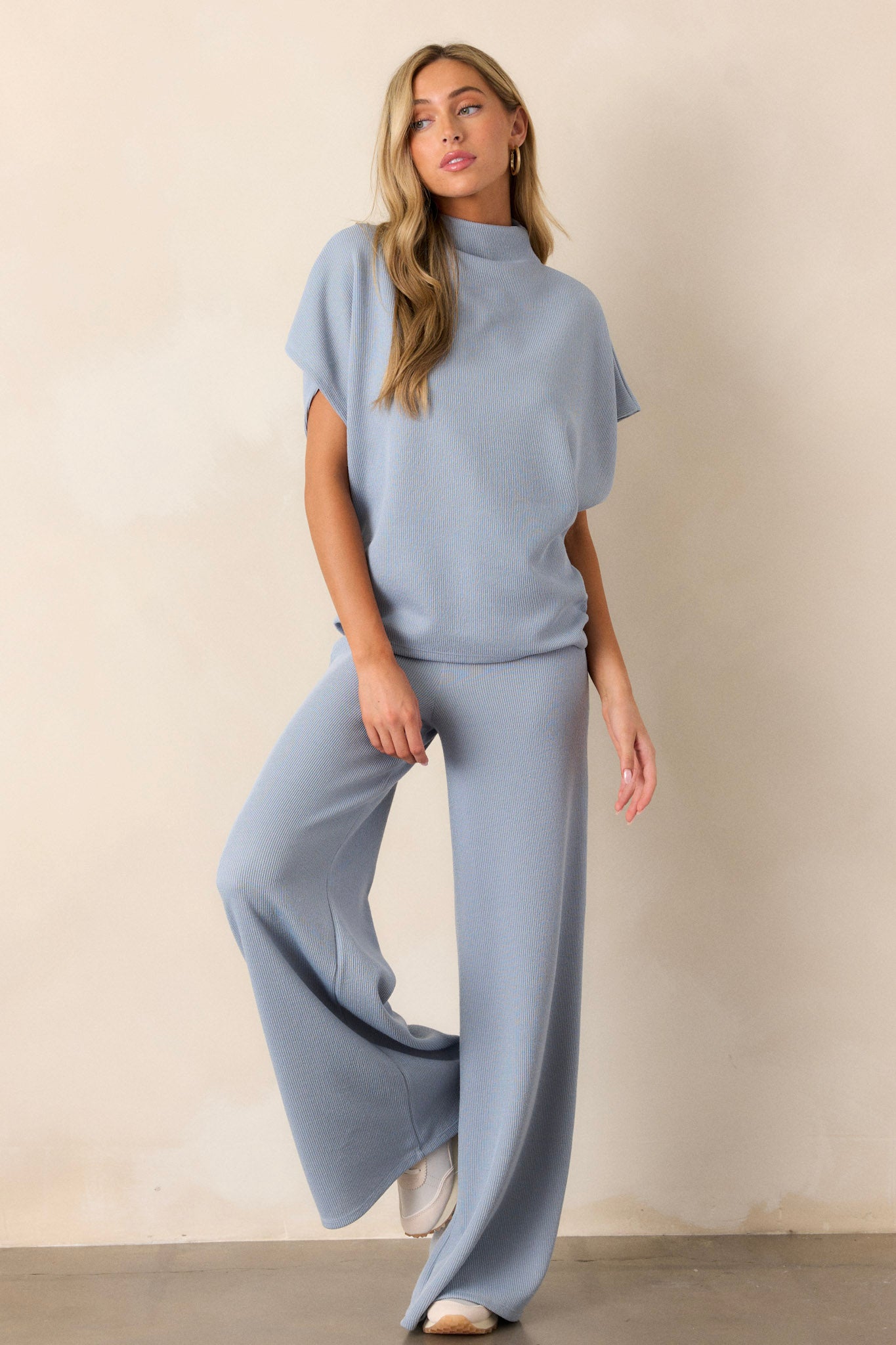 These blue knitted pants feature an elastic waist band, a high waisted design, a knit towel like texture on the outside, a soft inside and a wide leg.