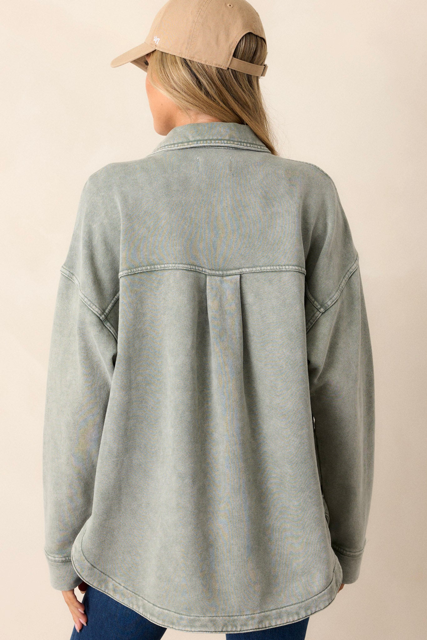 Back view of the jacket highlighting the dropped shoulders and the back of the collar, with a glimpse of the chest pockets from the side