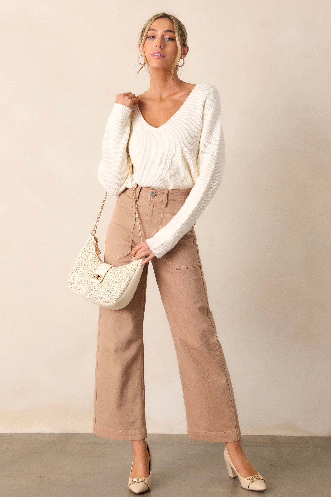 Full length view of tan jeans with a high waisted design, button & zipper closure, belt loops, functional front & back pockets, and a wide leg