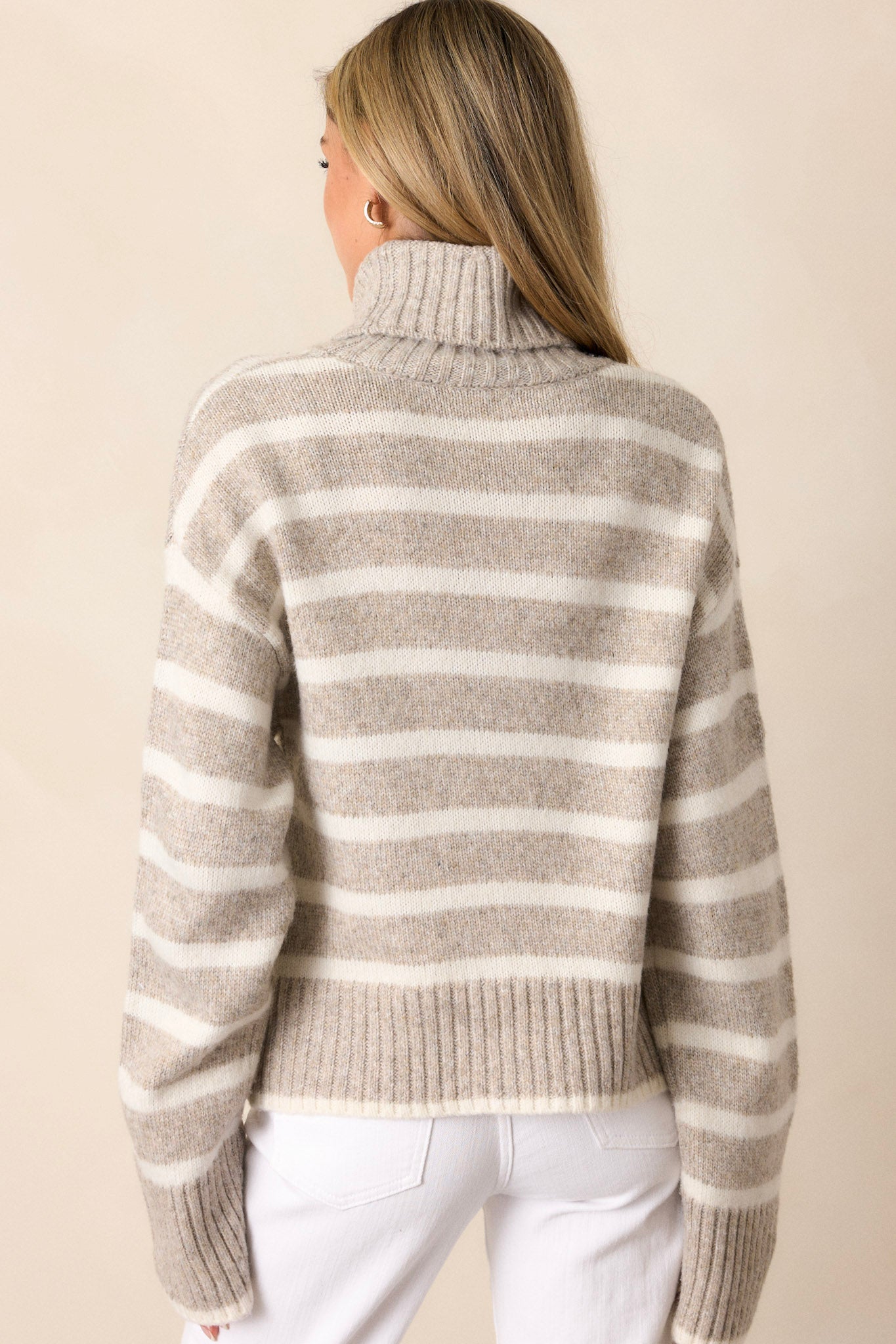 A view of the back of the taupe top, showcasing the clean lines and continuation of the ribbed design throughout.