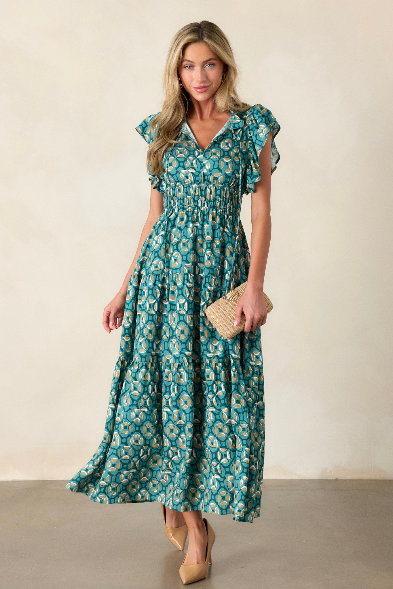 This green maxi dress features a ruffled v-neckline, a self-tie drawstring neckline, elastic waist bands, functional hip pockets, a tiered design and short ruffle sleeves.