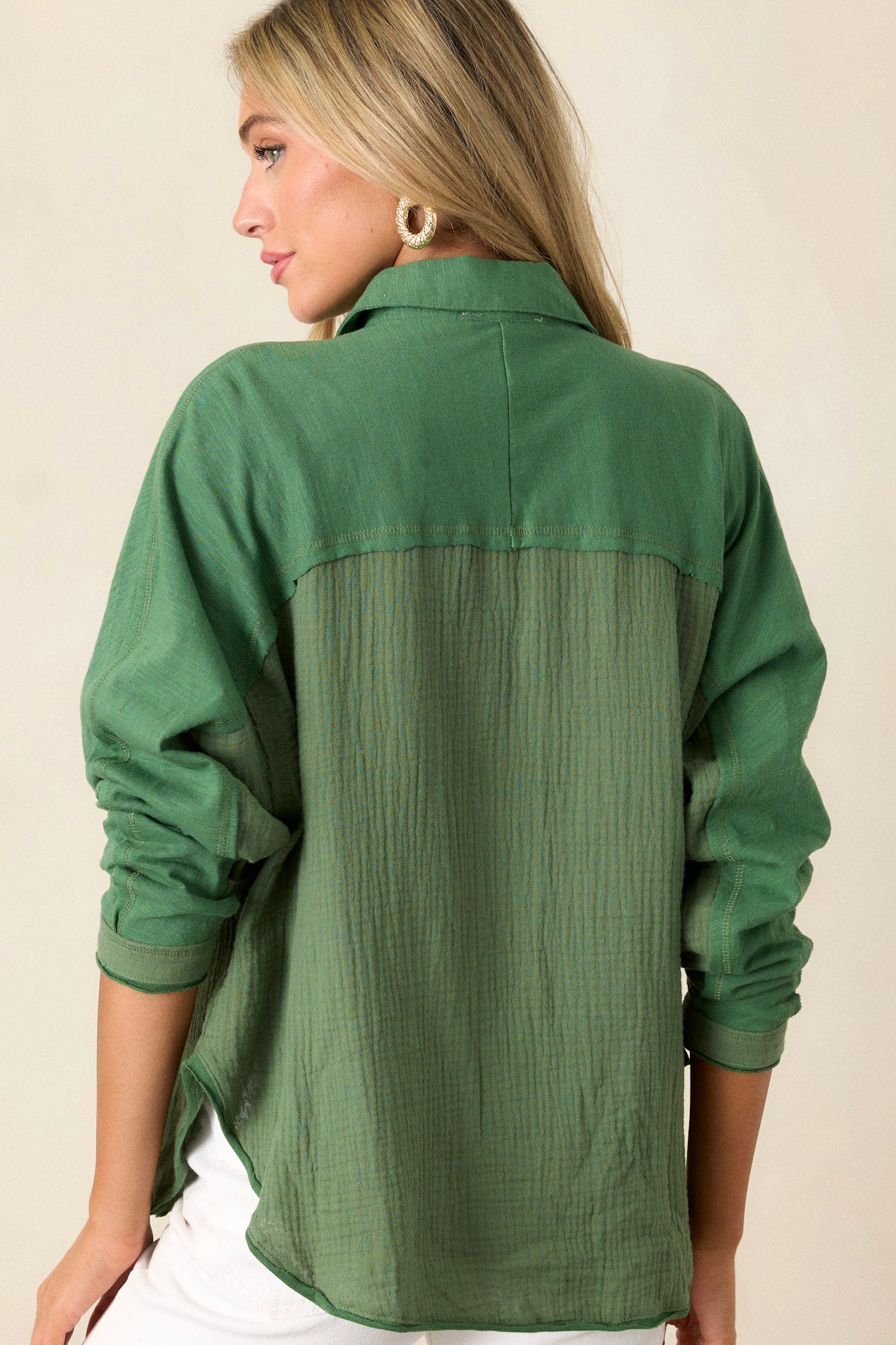 Back view of this top that  features a collar neckline, button down bodice, and one front functional pocket.