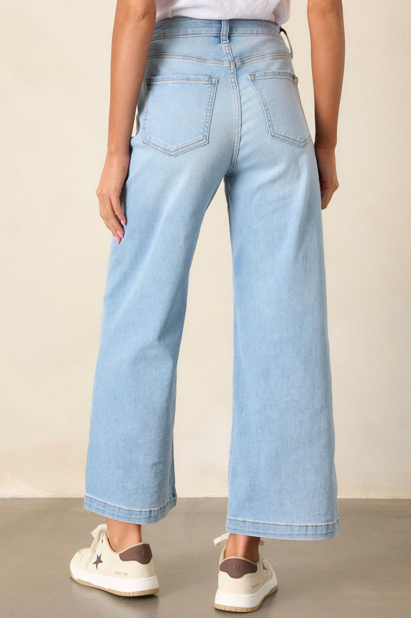 Back view of wide leg jeans highlighting the overall fit, functional back pockets, and wide leg design.