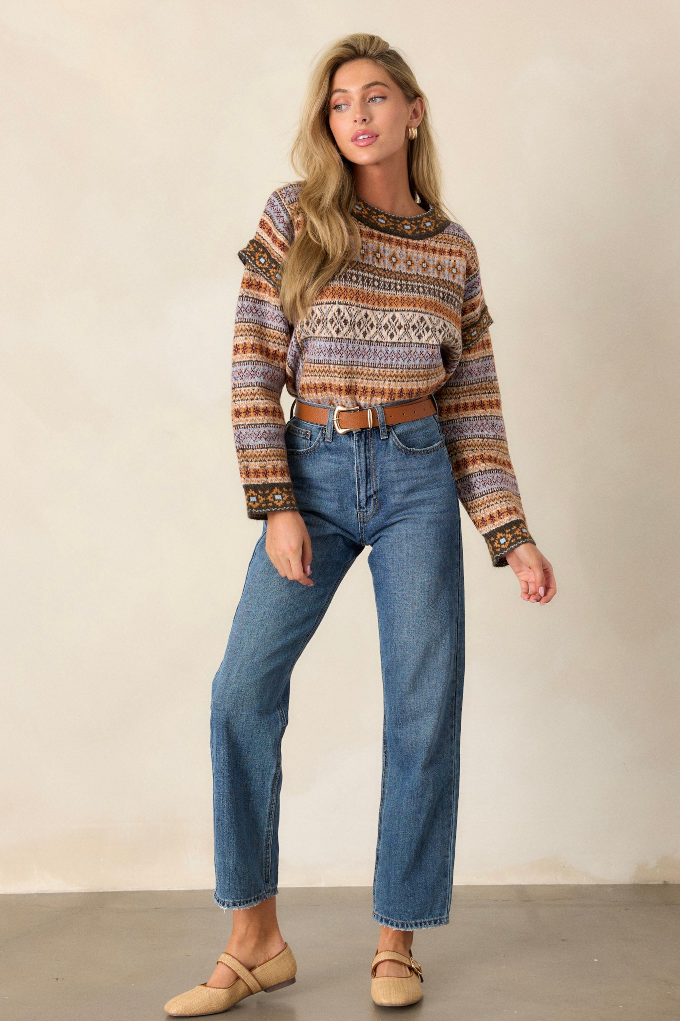 Full length view of a sweater featuring a scoop neckline, slight mock-neck, raw hems, and a slightly cropped fit