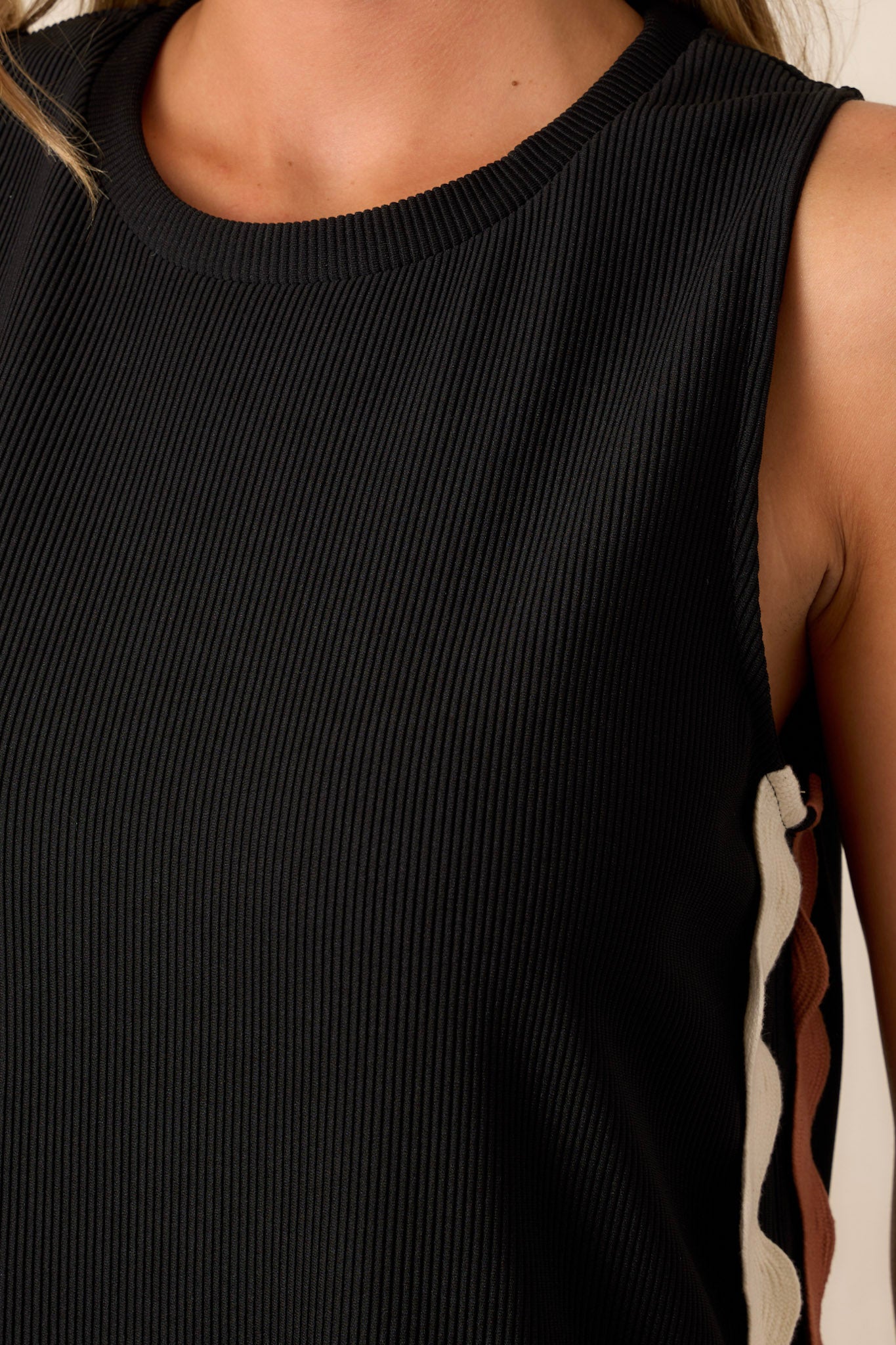 Close-up of the black midi dress focusing on the two-toned ricrac side detailing and the ribbed texture of the material.