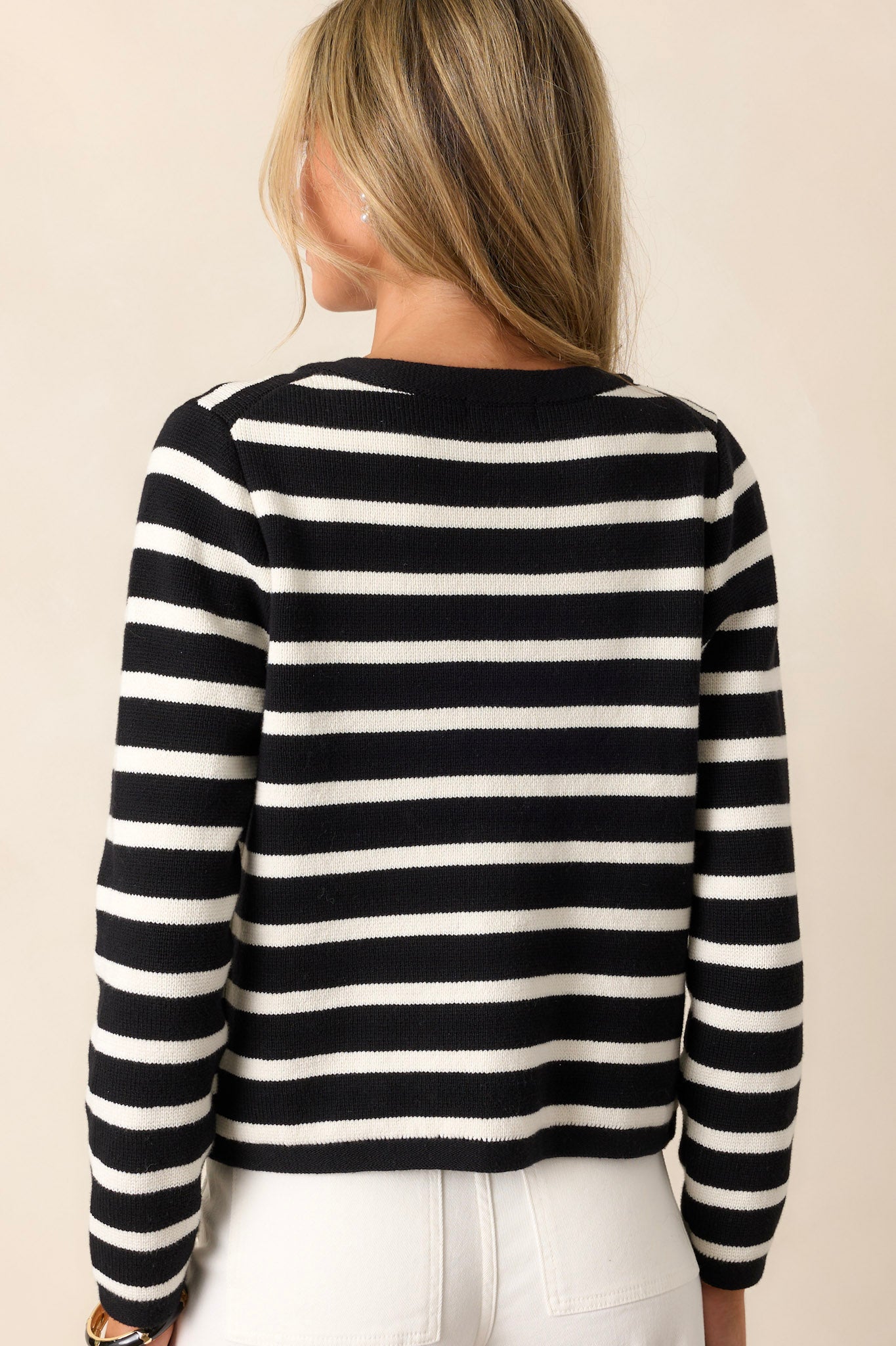 Back view of a cardigan highlighting the crew neckline and the overall silhouette, with a clear view of the back details.