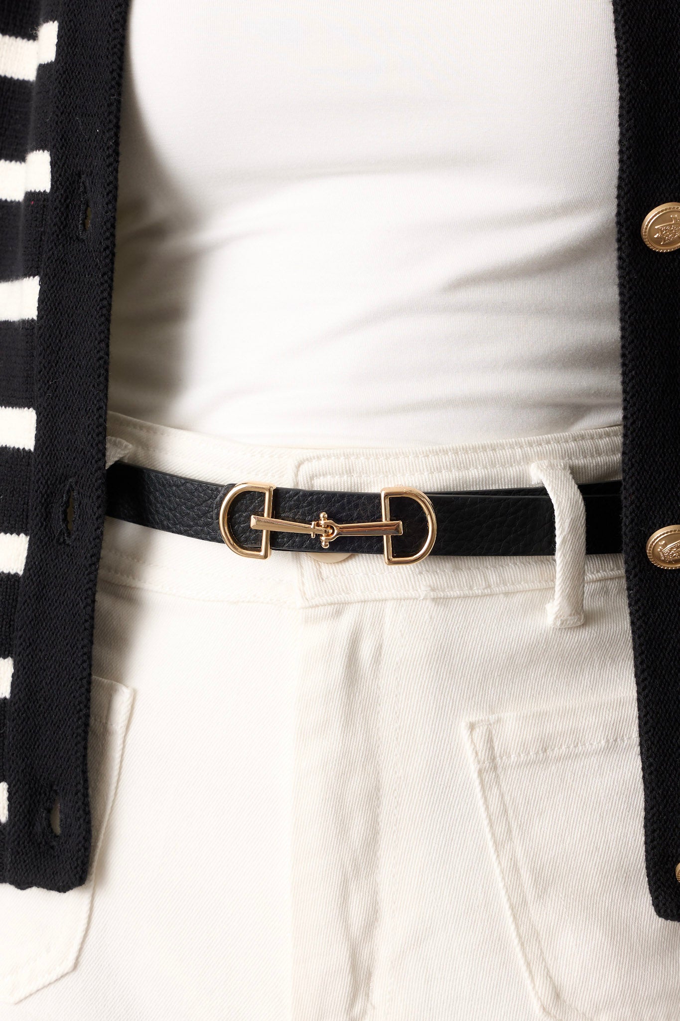 This black belt features gold hardware, an anchor closure, and a textured design.