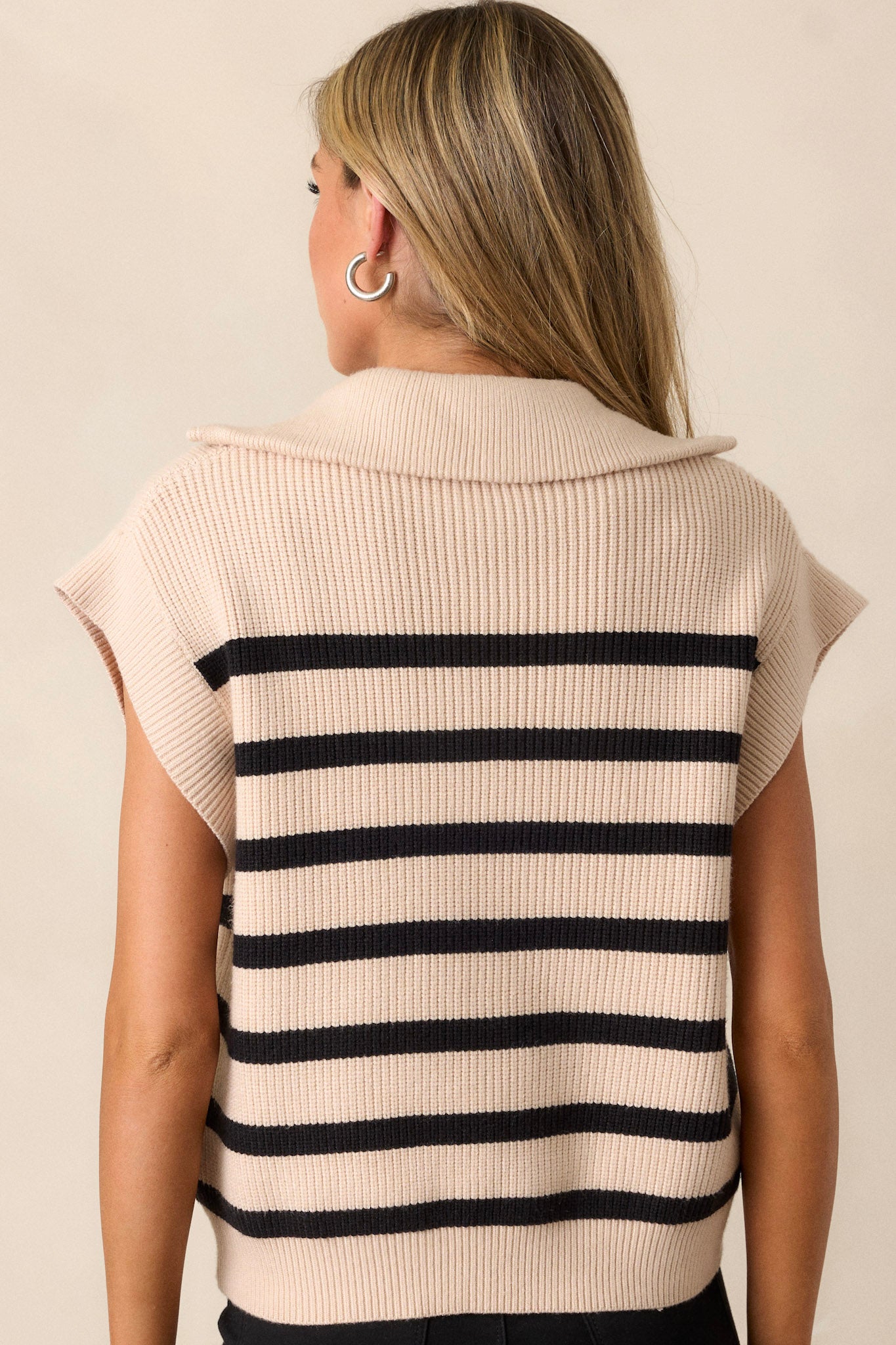 Back view of this Ecru top featuring a collared neckline, a functional front zipper, a classic horizontal stripe patter, cap sleeves, a thick hemline and a relaxed fit.