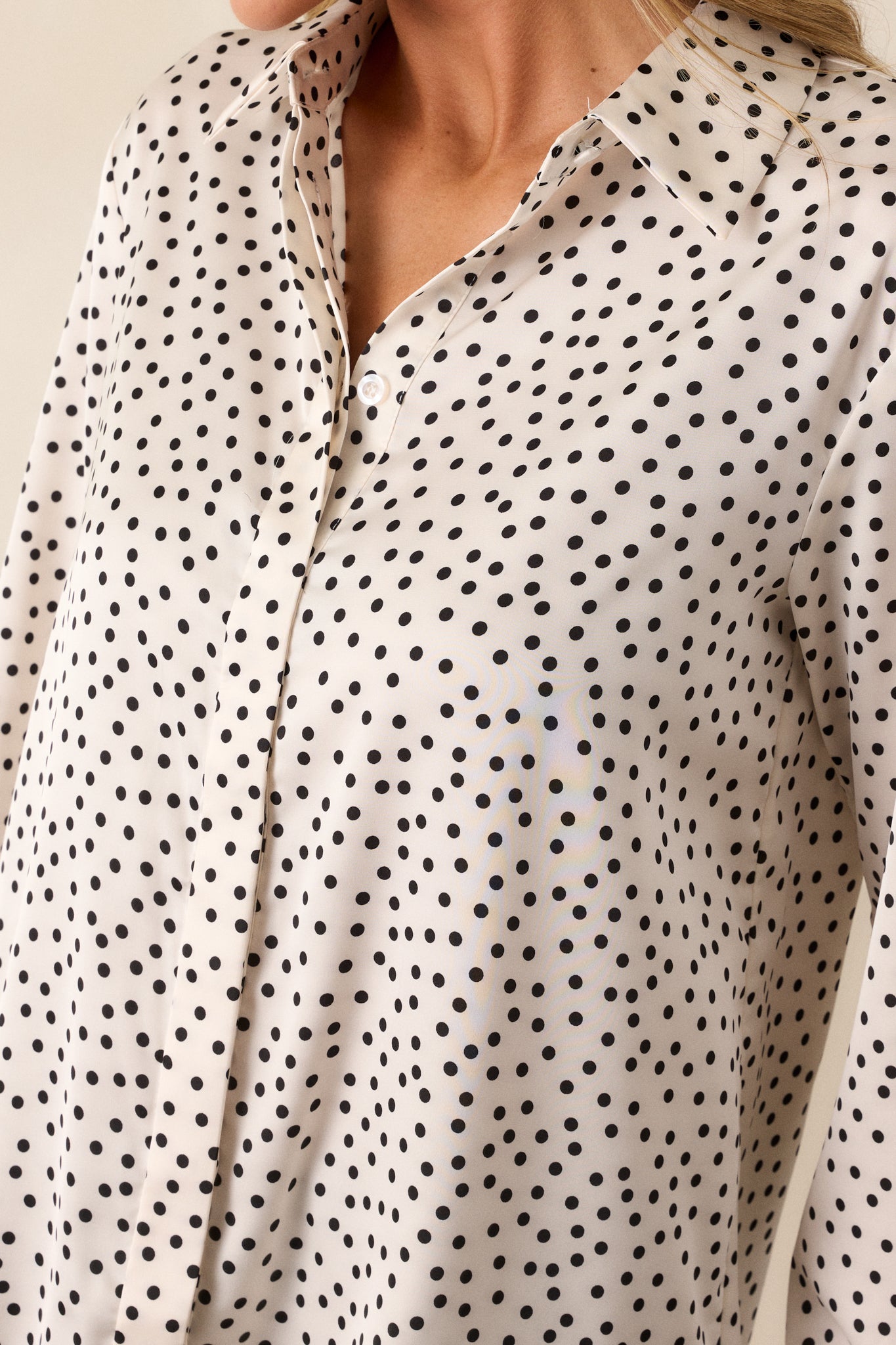 Detailed close-up of the polka dot pattern and texture of the fabric, showcasing the silky feel and craftsmanship of the top.