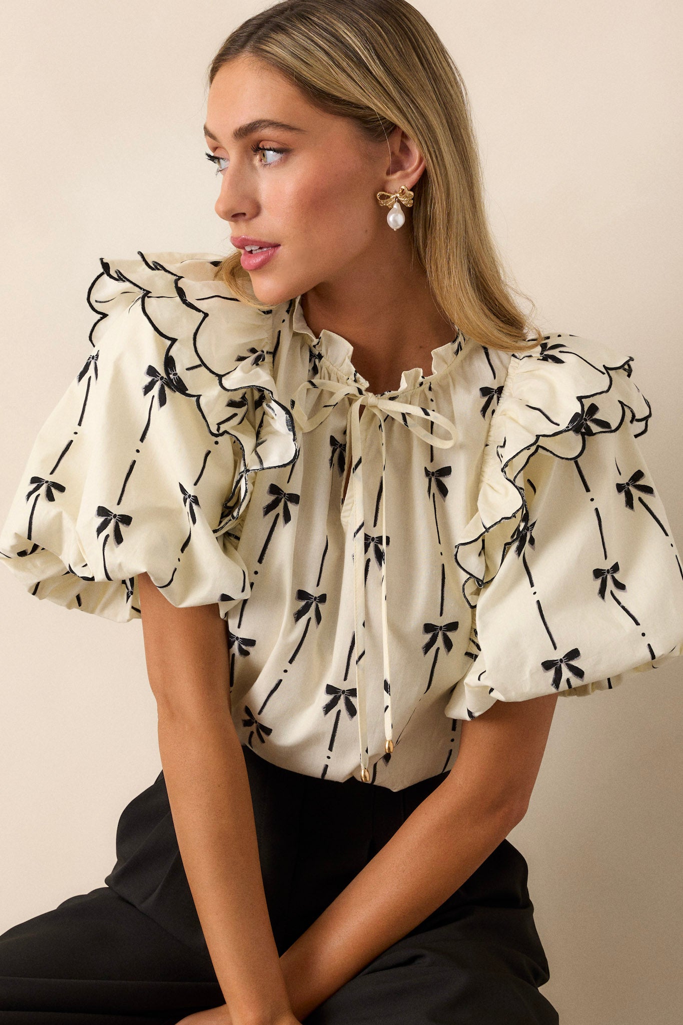 A cropped image focusing on the puff sleeve, showing the elastic cuff, the short length of the sleeve, and the ruffle details.