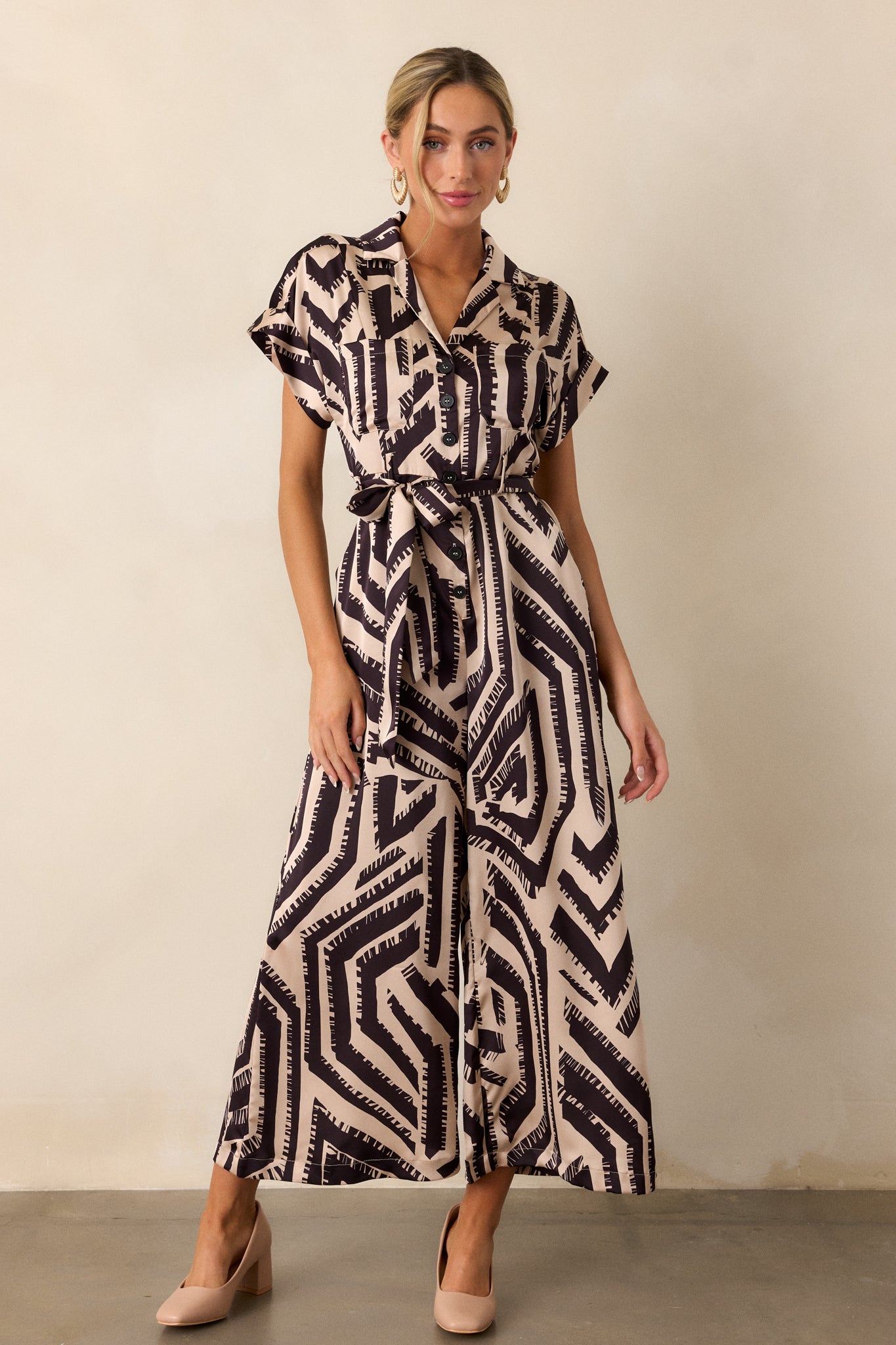 A front-facing view of the jumpsuit, emphasizing the cuffed short sleeves and how they complement the overall design.