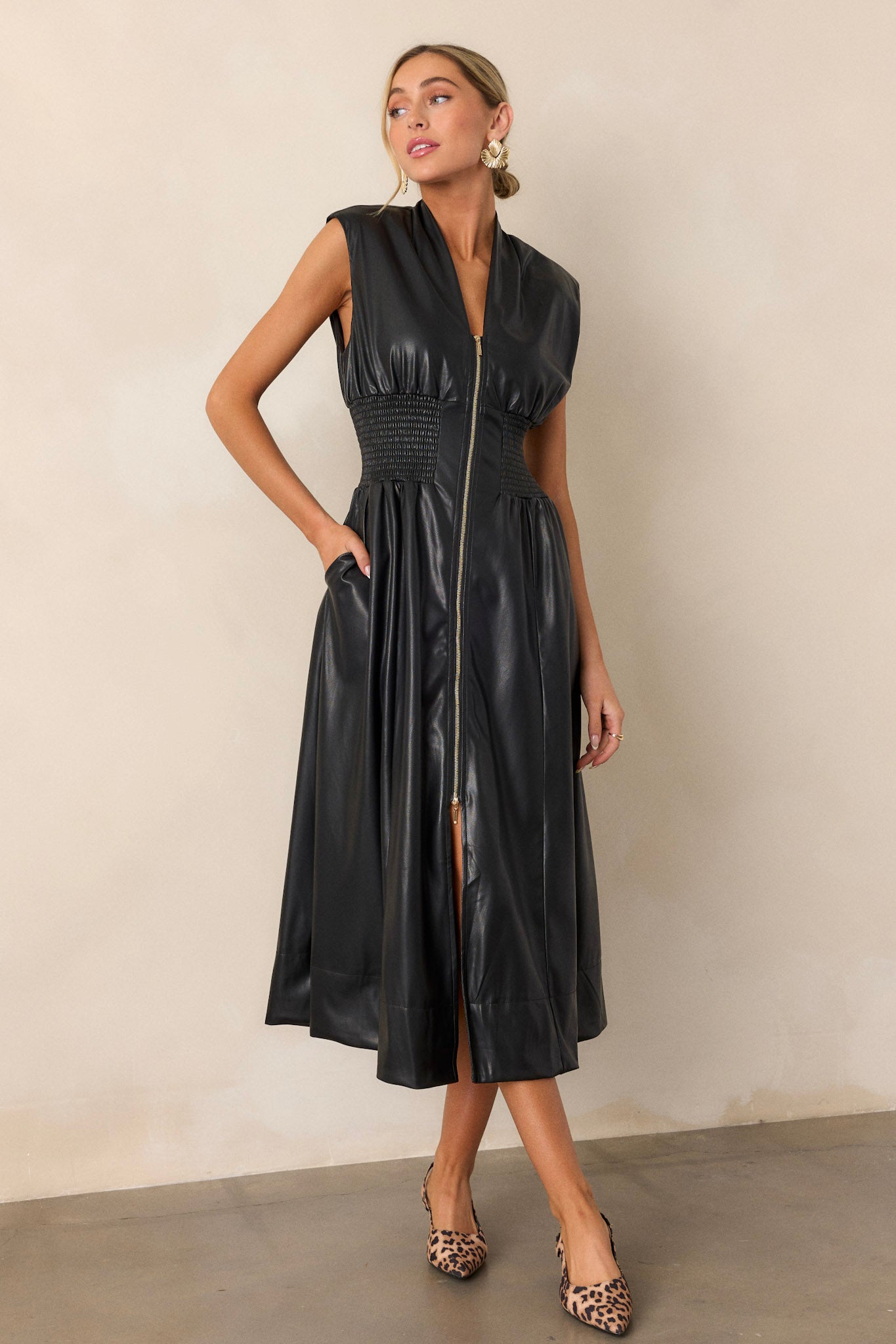 Full body image emphasizing the front slit, v-neckline, and the way the smocked waist defines the dress’s fit.