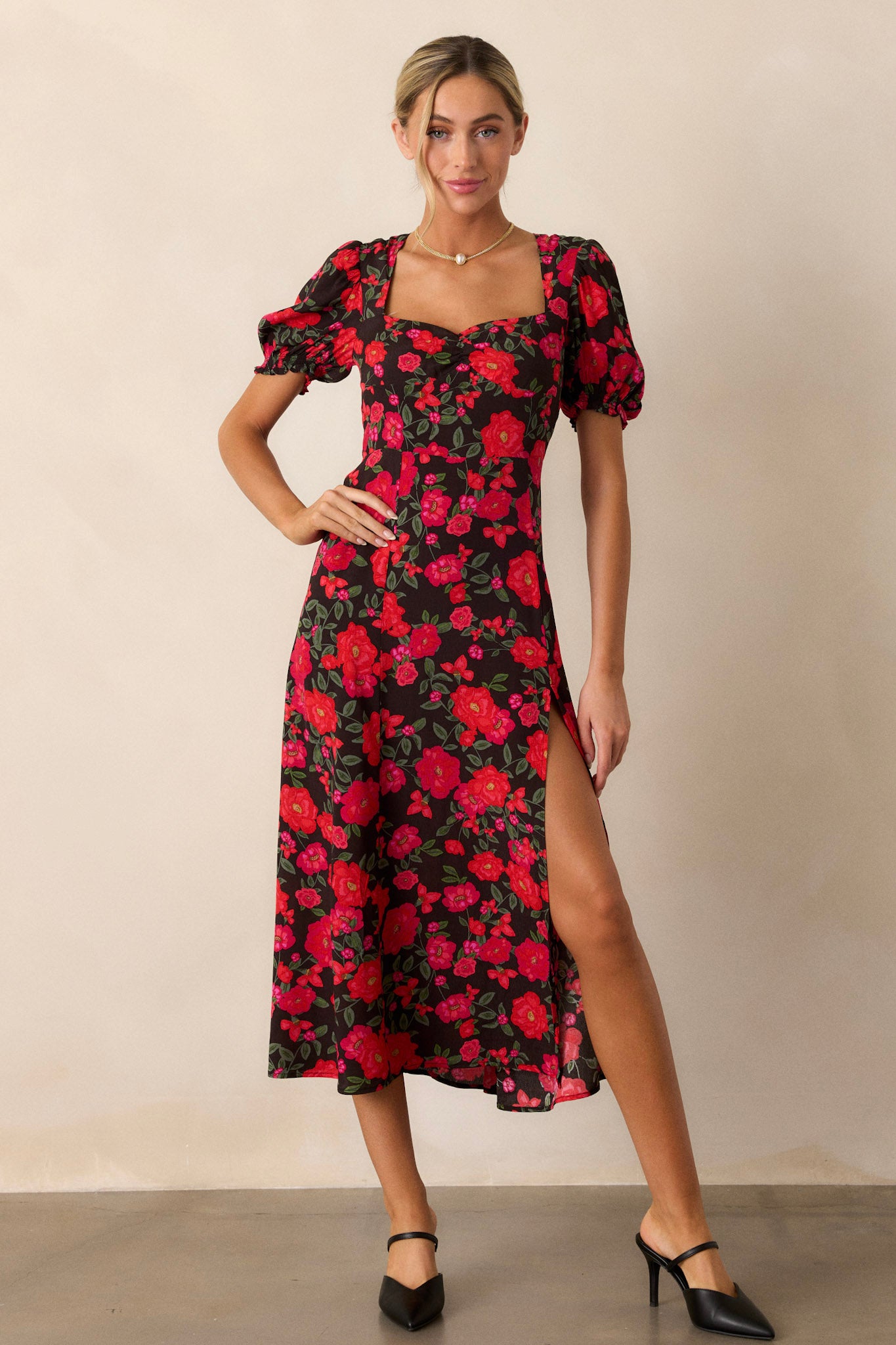 A full view of the dress highlighting the large slit in the left leg, accentuating the flow of the fabric and the floral pattern.