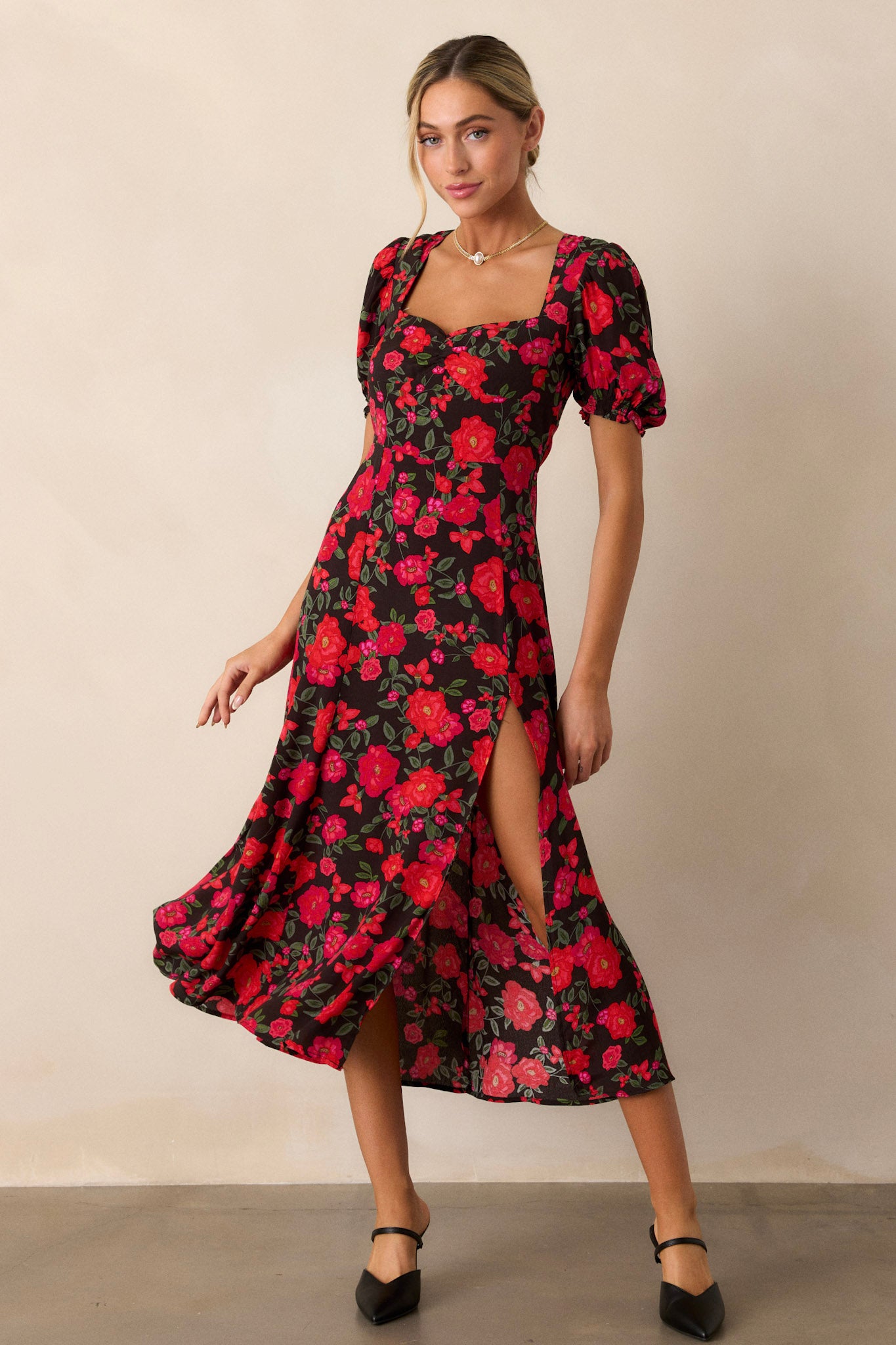 A side view of the dress highlighting the large slit in the left leg, accentuating the flow of the fabric and the floral pattern.