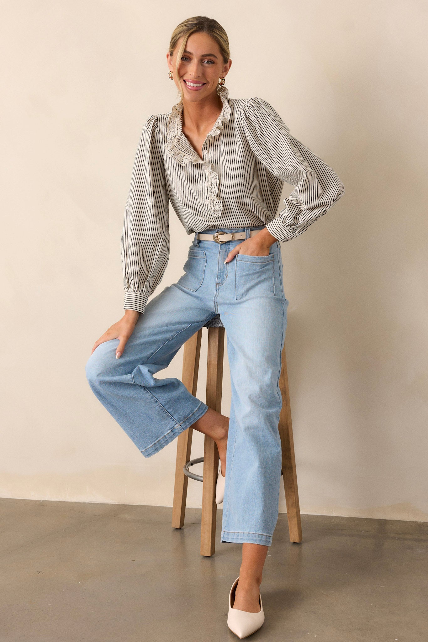 Full body view of this navy stripe top that features a lace collar, a functional button front bust, a vertical stripe pattern, navy and ivory stripes and puffed long sleeves.