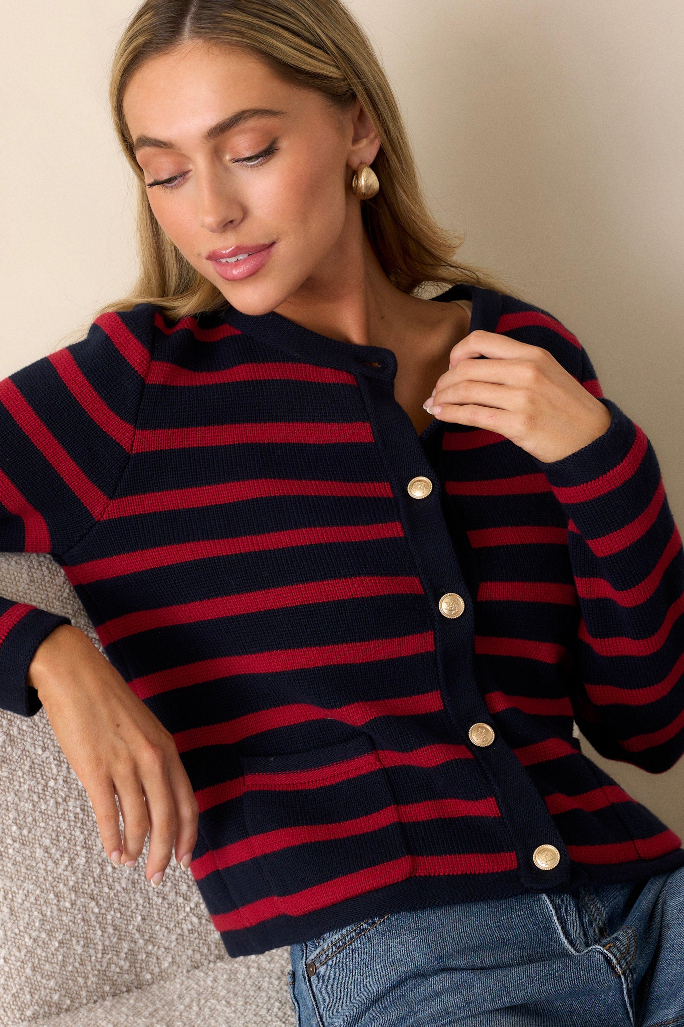 Front angled view of a cardigan featuring a crew neckline, a full button front with detailed gold buttons, and functional pockets