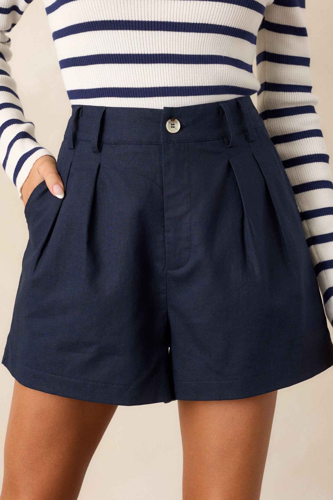 A closer view of the shorts, emphasizing the pleats and the functional front pockets.