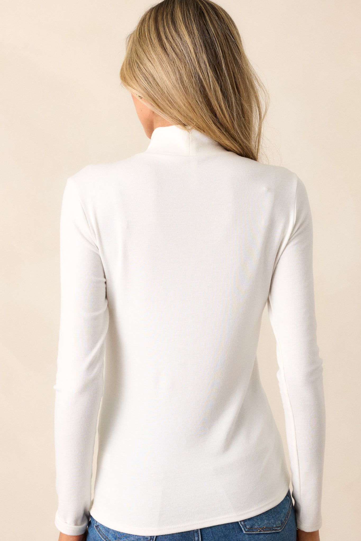 A rear view of the top, displaying the simplicity and timelessness of the design while highlighting the flow of the fabric along the back.